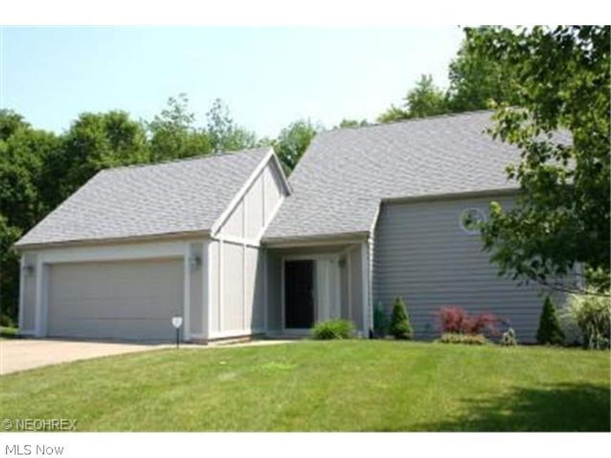 Lots of updates in this bi-level home situated in great north-end location close to shopping, grocery, banks, doctors, hospital, restaurants, etc. Updates include new wood laminate flooring in upstairs hallway and bedrooms, cork flooring in master bathroom, newer closet organizers, stainless appliances, plus a newer garage door and deck.  Neutral carpet new in 2009 in living room and dining room.  This home offers split entry w/lower level open concept w/lots of windows to allow for natural light. The living room has a corner fireplace w/gas logs (never used by present owner), slider to rear deck; dining area off living room w/ breakfast bar has another slider to side deck; and galley style kitchen offers ceramic tile floor, stainless steel refrigerator, stove, and dishwasher. There is also a half bath and lots of closet space on the lower level.  The second level offers 2 bedrooms and 2 baths including a master suite w/two closets and full bathroom w/cork flooring.  Laundry room is al