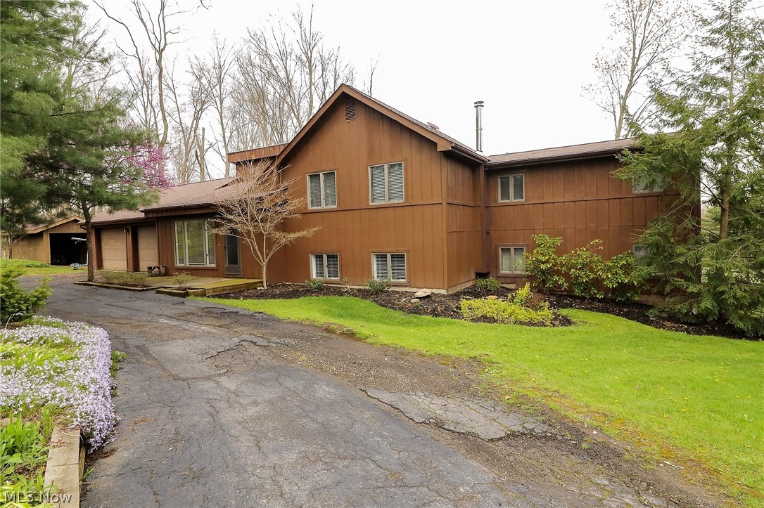 A home for all seasons! Welcome to this picturesque, unique four-bedroom, three full bath split level home all on 2.57 acres. WOW! The large living room has slider door to the covered all season room with hot tub. There are abundant of windows to let the natural sunshine in this gorgeous home. The bright, beautiful open eat in kitchen has an abundant of cabinets, island, dishwasher, refrigerator, stove/oven, built in microwave, and slider door to the back deck overlooking the tranquil backyard. Great room is open from the kitchen. Three large bedrooms, and 1 full bathroom are on the main level. The master suite is on the lower level with another full bathroom and primary suite. There is a firepit out back. Plenty of space to entertain, play area for kids, etc or just to relax and enjoy the stunning views. There is a two-car attached garage with electric. You won't want to miss this fantastic home!
