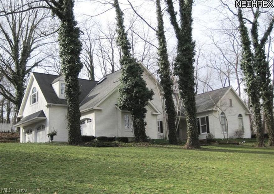 Truly a rare find in this spectacular updated colonial with newer additions.  Perched on a small hill with a country like setting, this property offers a unique blend of sophistication and charm.  Two story foyer and great room, complete with fireplace and wet bar, feature hardwood floors.  Gourmet kitchen with granite overlooks hearth room and eating area with brick fireplace. Large butlers pantry leads to formal dining room.  FF den, 5th bdrm/in-law suite, laundry rm.   Second level catwalk overlooks spacious great rm.  Vaulted master suite with sitting area, fireplace, steam shower, and whirlpool tub.  3 add'l bdrms and 2 full baths complete the 2nd floor.  Finished LL w/work out room.  Luscious landscaping w/lighted walkways. In-ground pool, pool house, and fabulous gardens. 3 c. gar.  Newer roof-8/13.  Close proximity to parks, downtown, and more. Outstanding city home with the country feel.