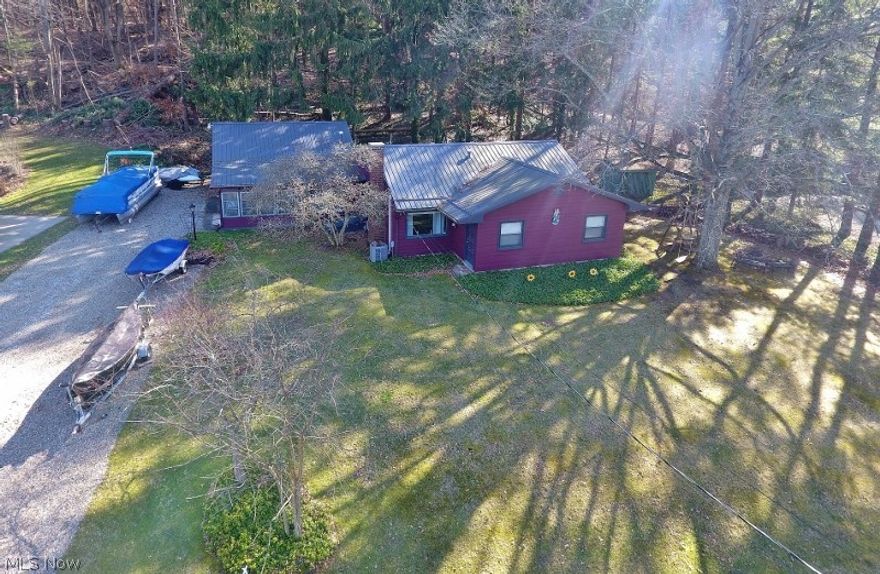 Perfect opportunity to own a Atwood lake home for your family to enjoy the upcoming lake season just around the corner in the popular Atwood Glens community. Enjoy the views of beautiful 1540 acre Atwood Lake as you enjoy your favorite beverage on your 4 season Sun Room. This lake home opportunity features one floor living & a open format living space for the spacious kitchen, dining area & living room. 2-3 bedrooms provides plenty of space for family & friends. The 3rd bedroom would also be ideal as a home office. 2 full bathrooms & laundry provides convenience for all. Of course, a private dock overlooking the Atwood Lake Dam is an easy walk away, just across the street. Not only is the floating dock included, how about a 22' Sweetwater Pontoon boat, trailer & 25 HP Yamaha 4 Stroke motor, also included. Great yard space with a swing, picnic table & fire pit for family fun. An oversized, heated 2 car attached garage is perfect for cars or your nautical toys storage. A shed provides ad