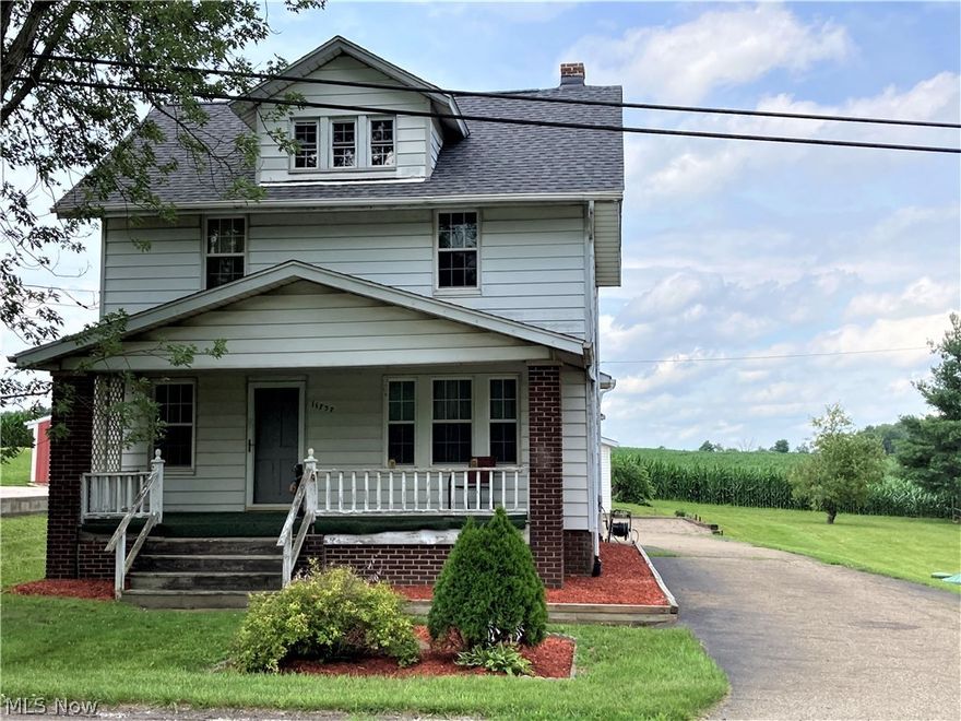 Spacious two story home sitting on a 1/2 acre lot.  Nice front porch PLUS a brand new back deck!  This home also has a new roof!  There is wood flooring through out the home.  Large living room and dining room.  The dining room has a corner cupboard and nice wains coating.  Spacious kitchen with plenty of cupboards, a pantry, and an island, plus the range and refrigerator stay with the home.  The main bath is roomy and has had some updates done. All three bedrooms are nice sized, and also a walk up attic!  The rec room has a bar area, and a propane gas fireplace.  There is another bath near the rec room.  The newer washer and dryer also stay with the home.  This is the perfect home for someone looking to do cosmetic updates!