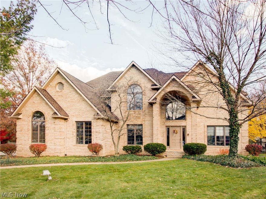 EXCEPTIONAL VALUE AT LESS THAN $80 PER SQ. FT. FINISHED LIVING AREA.  Gorgeous 5 bedroom 4.5 bath in the REVERE School District! Tucked away in a quiet cul-de-sac on a 1/3rd acre lot. Over 4,200 sq. ft. plus the finished lower level adds an additional 1,100 square ft. -- over 5000 sq. ft. of finished living area. Spacious and open floor plan with 9' ceilings, crown moldings, and rich hardwood floors. Grand two story foyer entry with a circular staircase. Rich paneled library. Upscale cherry kitchen with granite counter tops and eating area. Large family room overlooking the private lot with mature landscaping. The second floor includes 5 bedrooms and 3 full baths. Oversized master suite with a fireplace, private deck, luxurious bath and huge closet. Finished game room in basement includes 8 ft picture window, a wet bar and full bath. Quality construction throughout. 3 car side entry garage. New HVAC in 2015, new roof in 2010. Absolute Must See!
