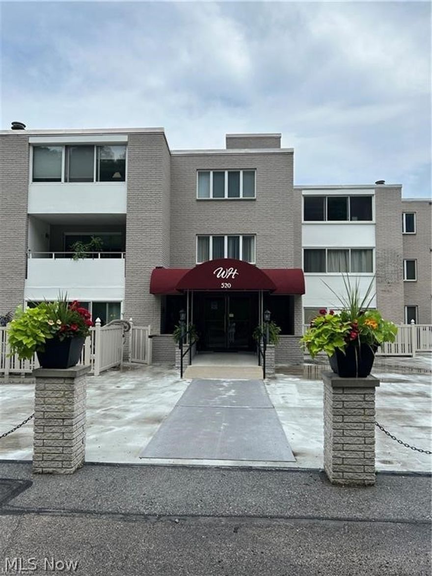 Welcome to easy, low-maintenance living in the heart of Cuyahoga Falls! This spacious 1700 sq. ft. fifth-floor condo, the largest unit in the building, offers the convenience of one-level living combined with generous living and entertaining spaces. Step inside to a large living room with an adjoining dining area, perfect for gathering and relaxing evenings at home. The bright enclosed sunroom provides the perfect spot for morning coffee or year-round enjoyment. The well-designed floor plan includes two comfortable bedrooms, a walk-in laundry closet, and an expansive bonus room featuring custom built-ins, a wet bar, and a large storage closet-ideal for a home office, media room, or hobby space. Residents enjoy exceptional community amenities, including a beautiful in-ground pool, garage parking, fitness room, recreation room with pool table, library, and a welcoming common lounge with a brick fireplace. There is also a party room available for hosting gatherings and special events. The HOA provides outstanding value, covering all utilities, exterior maintenance, and landscaping, allowing you to enjoy a truly carefree lifestyle. Conveniently located near shopping, dining, and parks, this condo offers everything you need all under one roof.