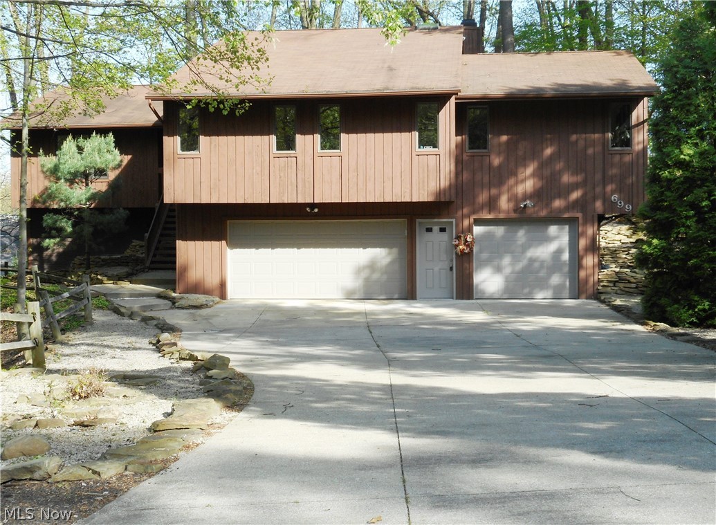 Prime location! Two Parcels in Merriman Woods on secluded and private cul-de-sac. This spacious, beautiful 4 bedroom, 3 full bath raised ranch offers 3024 SF of living space and many rooms have been freshly painted. The expansive eat-in kitchen offers newer appliances (double ovens), a pantry, ceramic flooring and sliders that open to the deck for easy entertaining. Enjoy the seasons with breath taking views from the dining room, kitchen, living room and family room with more sliders that lead to the huge deck and wooded lot. A gas fireplace accents the family room and is perfect for those cold winter nights. The master bedroom boasts a 7 X 10 walk-in closet and a full bath with an updated, large walk-in shower and double vanity. The guest bath also features double sinks and a skylight that provides lots of natural light. The finished lower level offers a rec room (new carpeting 6/17) full bath (new flooring 6/17), laundry room (new flooring 6/17) and additional sliders leading to a