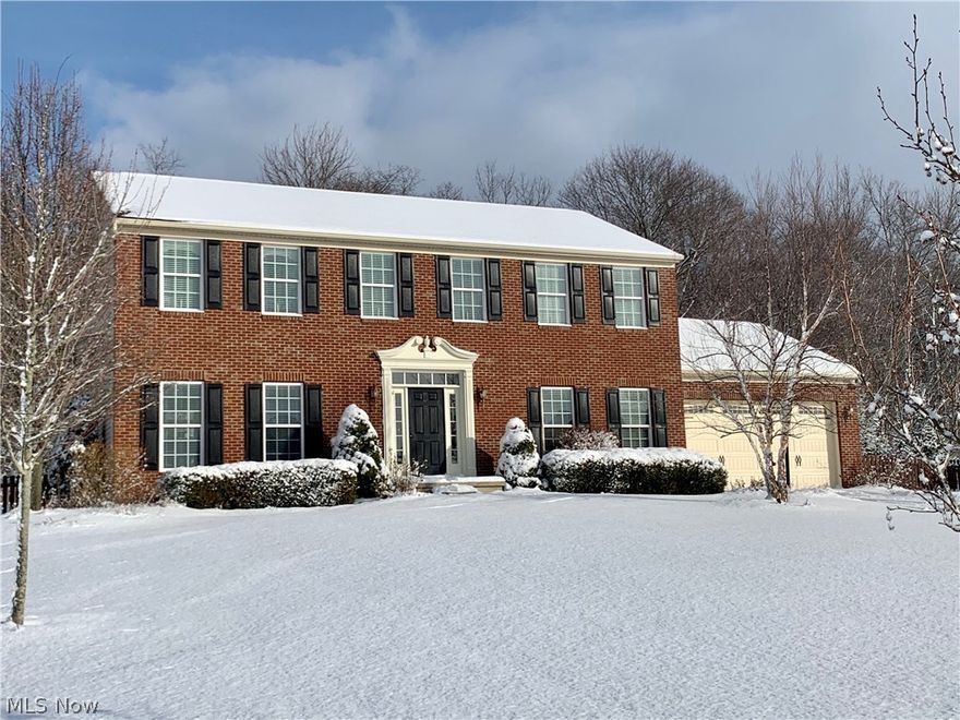Fabulous brick front custom colonial in Richfield Village presents open floor plan and numerous updates.  Formal living and dining rooms feature hardwood flooring and neutral decor.  Gourmet kitchen boasts granite island/breakfast bar, maple cabinetry, newer SS appliances except gas range, Corian counters, and sliders to vaulted screened porch.  Inviting porch with stone fireplace overlooks level landscaped yard with backdrop of woods. Engaging great room offers gas stone fireplace and wall of windows.  Spacious master suite with glamour bath and walk-in closet.  Three additional generous sized bedrooms and full bath complete the second level.  Finished lower level features family room, exercise/playroom, and ample storage.  Notable highlights include nine foot ceilings on first floor, shed, kids playset, paver patio, newer landscaping.