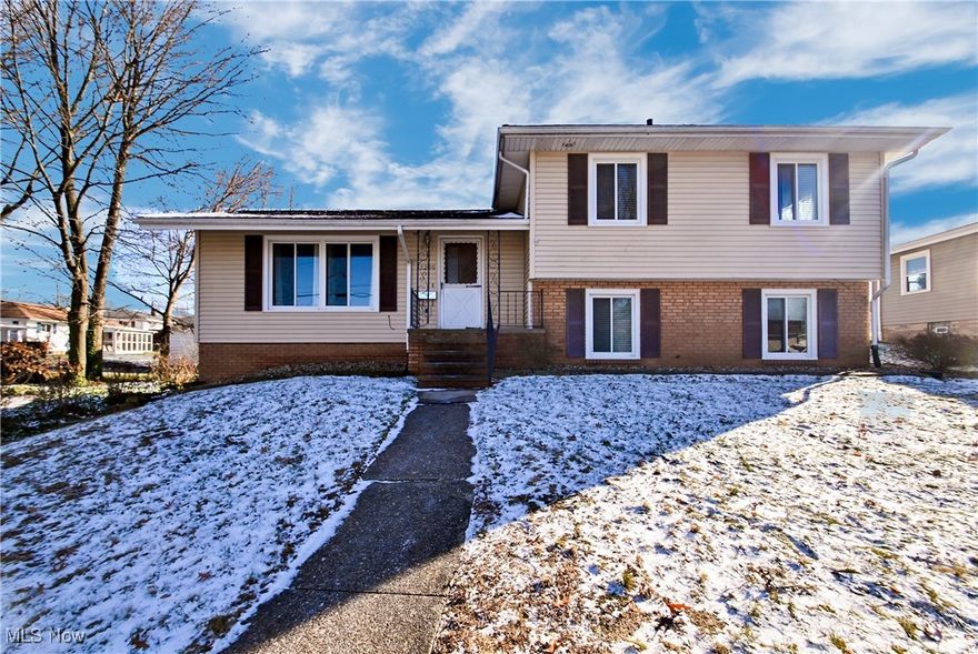 This charming 1740 square foot split-level home, located at 2200 Springfield Center Road in Akron/ Eastgate Heights, offers the perfect blend of space, style, and comfort. The home features three spacious bedrooms, two full bathrooms, a large living room, and a family room. Hardwood floors add warmth and character to the living room, second floor, and bedrooms, while vinyl flooring in the kitchen and dining room provides a practical and easy-to-clean surface. The kitchen has been updated with some modern appliances, yet retains its vintage charm with a classic backsplash and sink. The adjacent dining room is generously sized, perfect for hosting family gatherings and dinner parties. The lower level of the home offers additional living space, with a cozy family room, a full bathroom, and a convenient laundry room. The lot is 0.28 acres, providing ample space for outdoor activities and relaxation. A two-car garage, located at the back of the home, offers private parking and additional storage space. A covered patio off the lower-level family room is the perfect spot to unwind and enjoy the fresh air. This wonderful home offers the perfect combination of comfort, style, and practicality, making it an ideal choice for anyone looking for a spacious and welcoming living space.