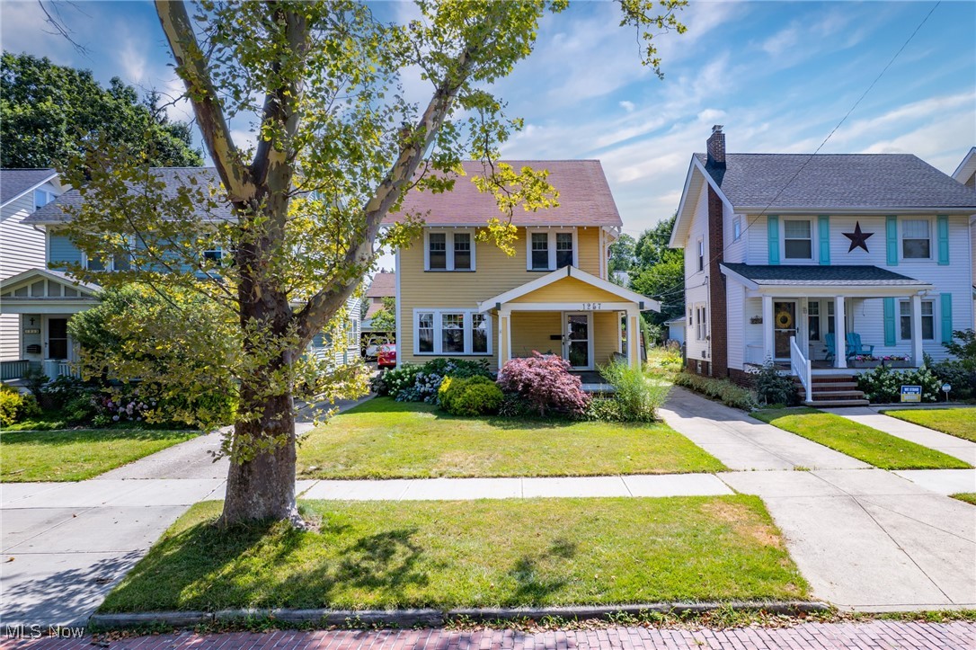Nestled on charming and desirable Virginia Ave, this beautifully maintained 4-bedroom, 2-bath Colonial blends classic character with thoughtful and modern updates. A welcoming front porch overlooking a perennial garden and brick, tree-lined street perfectly sets the tone. Inside, you'll find all the things that make people fall head over heels for century homes - original hardwood floors, crown molding, built-ins, room centering fireplace and more. The main level has been freshly replastered and painted, creating a crisp and updated feel while adding timeless appeal. The spacious living and dining rooms offer an ideal layout for entertaining, while the adjoining flexible space makes for a perfect family room, office, or play area. The generously sized kitchen is a showstopper and features gorgeous granite countertops, custom dovetail cabinetry with abundant storage, full suite of stainless-steel appliances and peninsula with view of the back deck. Step out to a true outdoor retreat with a newly installed aluminum fence enclosing the backyard—ideal for pets or play. Relax on the back deck or garden in peace and privacy. The first-floor full bath with a walk-in shower adds versatility and convenience. Upstairs, three sizable 2nd floor bedrooms boast high ceilings and great closet space, complemented by a full hallway bath with tub/shower combo. The finished third floor serves as a stylish fourth bedroom option or flex space and boasts modern flooring and a skylight for natural light. The lower level has a great laundry area with washer/dryer included and has all the storage space one could want! Recent major updates and highlights include a brand new AC system, newer vinyl windows and an oversized two-car garage. Some of Lakewood's greatest attractions are between one and a few blocks away! Kauffman Park, Lakewood Park and the Solstice Steps and expansive retail and restaurant options of downtown Lakewood are all within close proximity! Lakewood lifestyle at its best.