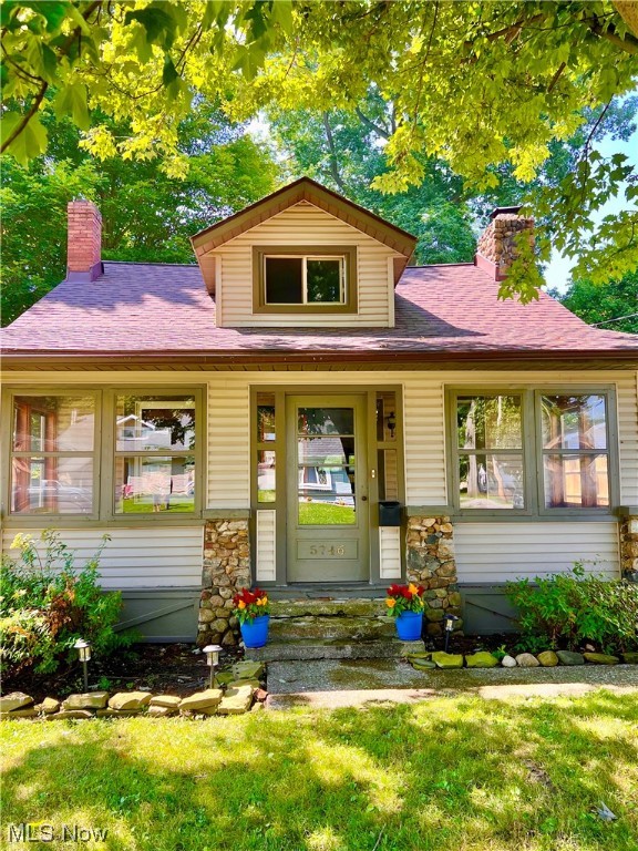 Why rent when you can buy? Come see this two bedroom bungalow with lots of big ticket upgrades. New roof and gutters in 2022 (full tear off). Upgraded and replaced new insulation throughout 2022. Full bath getting finishing touches on new flooring, toilet, tub/shower, and fixtures. Brand new steps going to second floor and newer carpeting upstairs (2020). Furnace and hot water tank replaced in 2019. New utility vanity, and faucet in laundry room, which also serves as half bath. In the kitchen with new refrigerator you will find maple cabinetry, granite countertops, island with breakfast bar, and mostly stainless steel appliances. The large kitchen window has a view of the fenced in backyard, and has been refinished to its original charm, along with many other windows with bold wood trim. The stone fireplace in the living room was converted to gas a few years back. The enclosed front porch has been maintained to keep the integrity of the space and provides a light airy environment with