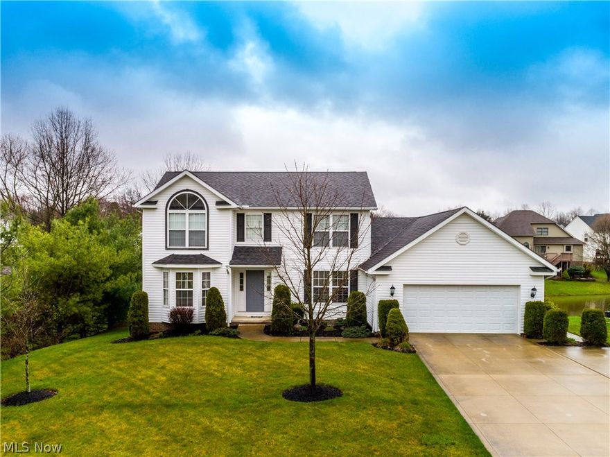 Truly a gem! Lovely setting on stocked pond, centrally located in City of Green, offering 4 bedrooms, 3.5 baths, approx. 3226SF including finished walk out lower level loaded with amenities* Starting with living room/great room great for entertaining or (office/great room)& gas log fireplace* Formal dining room* Eat in kitchen, bayed eating area with slider to deck (overlooking pond), island, granite counter top & fully applianced* 1st floor laundry with granite counter top/folding table* 1st floor half bath* Master bedroom with palladium window* Master bath with double vanity, corner soaking tub, shower, built in ironing board, ceramic floor & walk in closet* 3 additional bedrooms & guest bath complete the 2nd floor* Stair lighting leading to lower level recreation room with theatre (motorized screen, projector & speakers), built in book cases, bar with sink, refrig, microwave, (three mounted TV's to stay), full bath & additional room (office, exercise or play room) all with access to