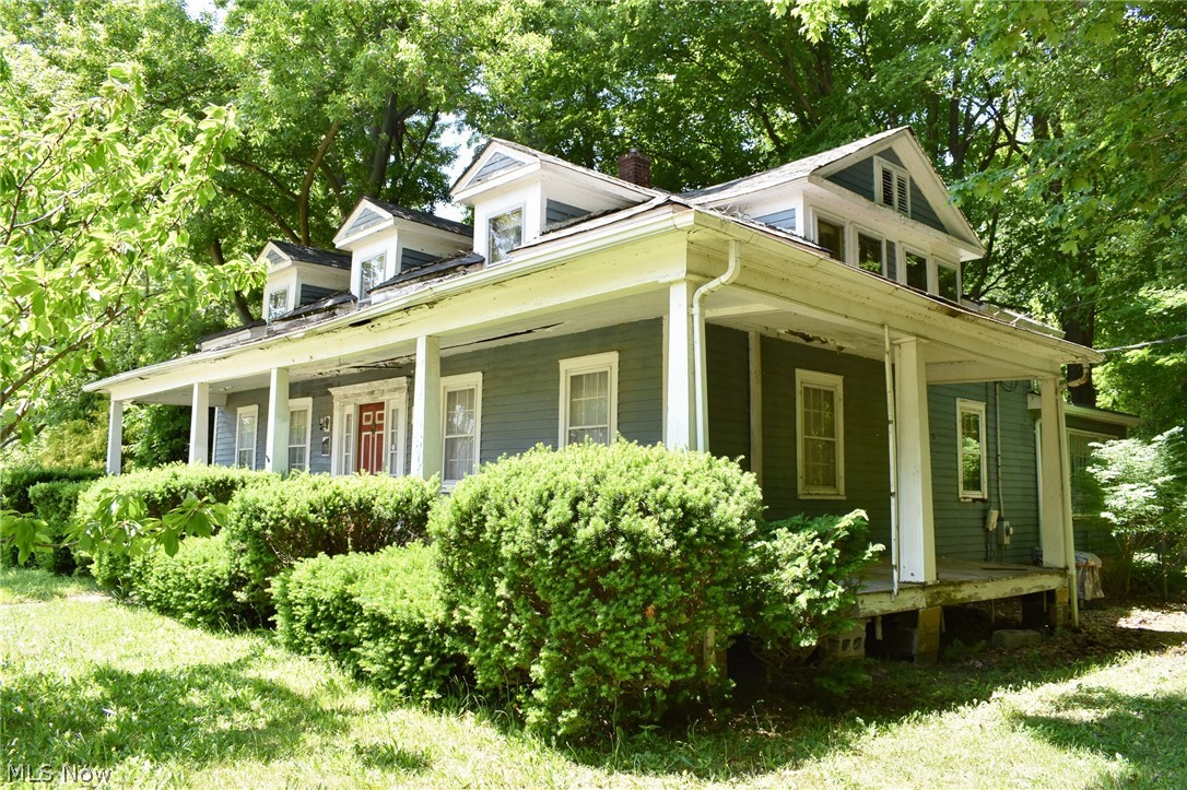 An historic beauty wishing to be restored to her former glory! This 2,765 sq ft home, situated on 1.73 scenic acres, dates back to pre-Civil War. The gorgeous property overlooks a ravine with a meandering stream to Lake Erie & offers Lake views from late fall through springtime. This home’s long past is evident in its unique features, including exposed hand-hewn beams, some original interior doors, 9 double-hung 6-over-6 sash windows with original brass hardware & hand-molded glass panes, and more. The footprint of this home includes 3 structures that were ingeniously assembled to create the large & inviting home standing today. First enter the 1845 house from the covered front porch & into the foyer with hw floors. The library boasts original woodwork with 12” baseboards and Greek Key design window frames. A large formal dining rm with secret built-ins leads to an expansive kitchen with additional dining area & wb fireplace. The over-sized living room includes French doors, a gorgeous