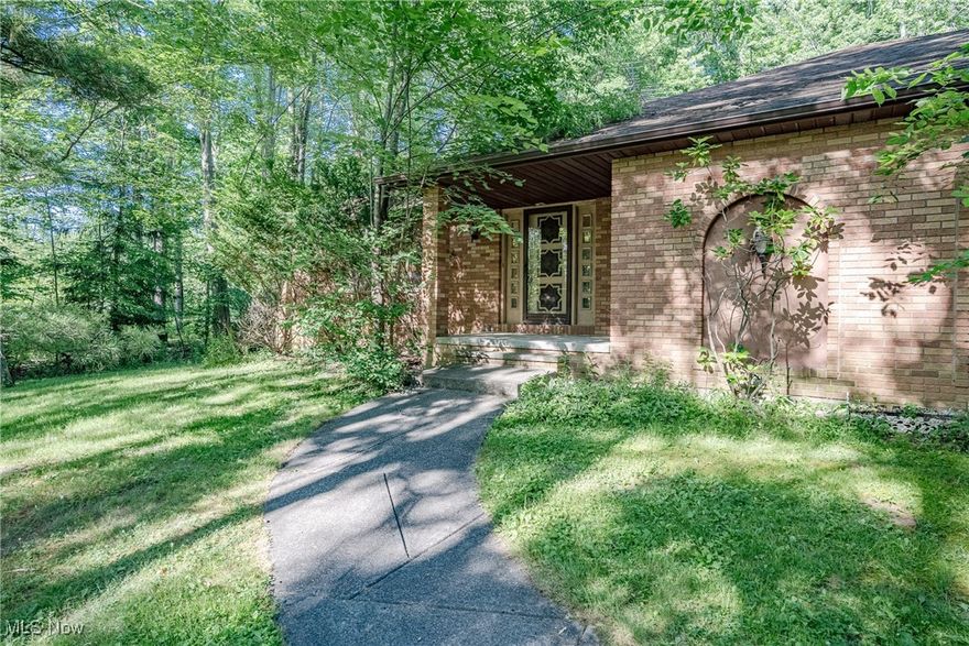 Welcome to 7005 Liberty Rd – Tucked away on an expansive, private lot, this all-brick ranch offers timeless appeal and an incredible setting—5 wooded acres in Solon, a truly rare opportunity. Step inside to a welcoming foyer that opens into an oversized living room with a bow window, filling the space with natural light. The formal dining room sits just beyond, perfect for gatherings and everyday dining alike. The spacious kitchen includes an eat-in area and flows into a step-down family room where you’ll find a cozy fireplace, built-in wet bar, and sliding doors to the back patio—ideal for relaxing or entertaining. The home offers three generously sized bedrooms, including a primary suite with an ensuite bath that conveniently connects to the family room. A second full bathroom is located near the additional bedrooms. The lower level expands your living space with a large rec room featuring a bar, plus a workshop area and an open laundry/utility space with ample storage. Out back, a pole barn offers excellent space for hobbies, storage, or equipment, and a bonus shed adds even more functionality. Whether you’re drawn to the peaceful setting, the solid construction, or the incredible acreage—this home offers a unique blend of privacy, space, and potential in a top-rated school district. Don’t miss this one-of-a-kind opportunity!