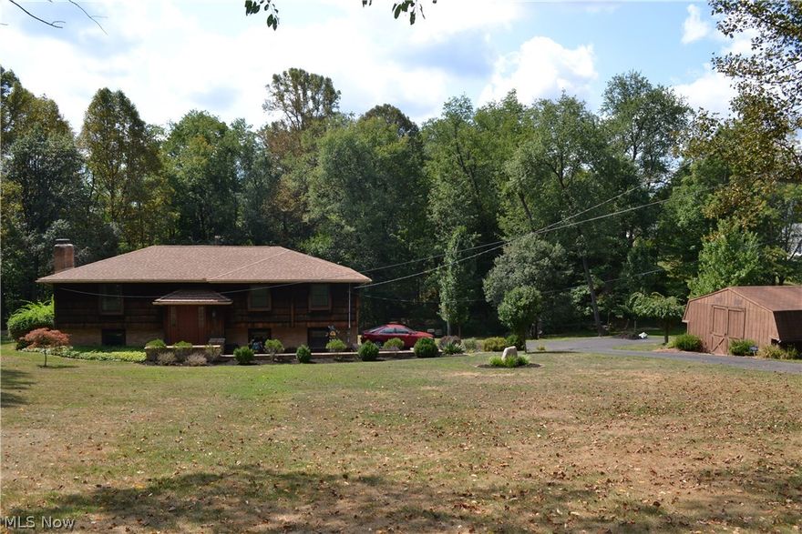 If you love nature then look no further! This stunning home is nestled on 5 wooded acres of the best mother nature has to offer. With over 2000 sq. ft. of living space, 3 bedrooms, two full updated baths and lots of updates you will fall in love with it inside and out. The huge kitchen boasts granite countertops, an island with bar stools and a full compliment of appliances that convey with the property. In the lower level is a family room with a brick fireplace, wet bar, the laundry and second full bathroom. Walk out the lower level into the fenced back yard with patio and walk up the steps to the second story deck which can also be accessed off the dining room. Do not wait to see this home. It is truly exceptional.