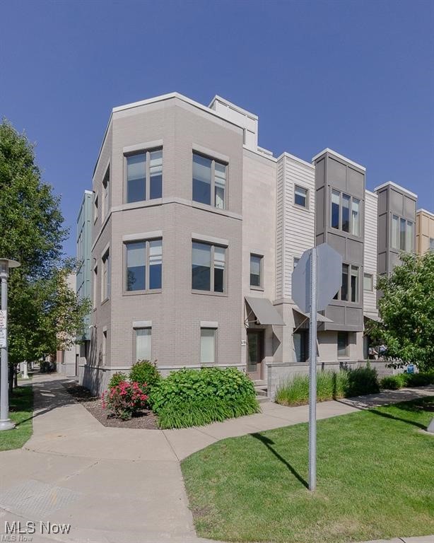 THIS could be THE PLACE! This rare spacious corner townhome is in the heart of downtown for you to enjoy the best city living in Cleveland near restaurants, Playhouse Square, and all sports venues. Enjoy ample living space across three floors. This residence has three bedrooms, each featuring a full bath and walk-in closet. The first level features the two-car attached private garage. Unlike most condos, the first floor features a large guest bedroom with an en-suite bath and walk-in closet. Walk upstairs, and you will be greeted by the abundance of natural light, wrap-around windows, and the open floor plan with sprawling hardwood floors throughout. The kitchen is a chef's dream, with loads of cabinetry, granite counters, a breakfast bar, and stainless steel appliances. The kitchen connects to the main living area, perfect for entertaining. Upstairs rests the expansive Primary Bdrm. with a private bath, soaking tub, spacious shower, vast walk-in closet, and his & her sinks. The 3rd floor also includes a conveniently placed laundry room and an additional 3rd bedroom with a full bathroom and walk-in closet. At the top of the townhouse is a rooftop deck with views of the city skyline and lake. Schedule a showing with an agent, and start living here in Cleveland.