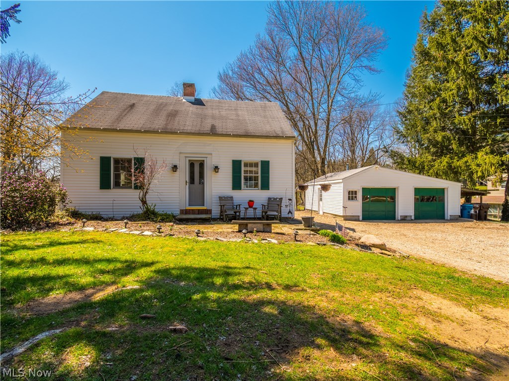 This is a must-see! This adorable cape cod sits on over 2 acres in Manchester LSD. Fully painted throughout plus a remodeled kitchen in 2014: white cabinets, butcher block countertops, laminate flooring, and two pantries. Two great sized bedrooms upstairs have built-in shelving, and the master bathroom has been recently updated with fresh paint and shiplap. A bonus room downstairs has double-closets and could be utilized as a third bedroom or play room! The living room has hardwood flooring, recessed lighting, and charming built-ins around the gas fireplace. You'll love how it opens up into a second living space lined with windows for plenty of natural light and to overlook the fully stocked pond! Pond features a beautiful fountain and a 15x14 dock, great for fishing or to jump right in for a swim! Relax on the 32x15 brick patio or take advantage of the walking path around the property. This home comes with a chicken coop, garden area, a goat barn that could easily be used as a storage