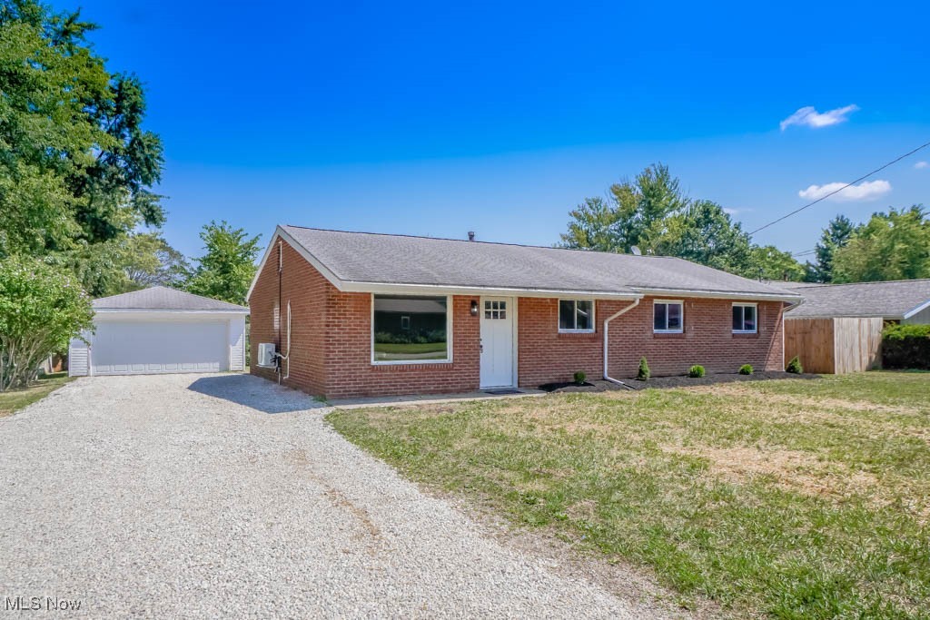 Enjoy true one floor living in this updated all brick ranch in Brimfield! A large picture window fills the living room with natural light, complemented by recessed lighting and new LVP flooring that flows into the remodeled kitchen. Here, you’ll find bright white cabinetry, stainless steel appliances, a subway tile backsplash, and access to the laundry room. A half bath sits off the hall that leads to three comfortable bedrooms with new carpet and an updated full bath with a tub/shower with tile surround. The backyard offers plenty of space to enjoy with a patio beside the detached two car garage. Notable updates include new windows, a hot water tank, and a mini split system. Schedule your showing today!