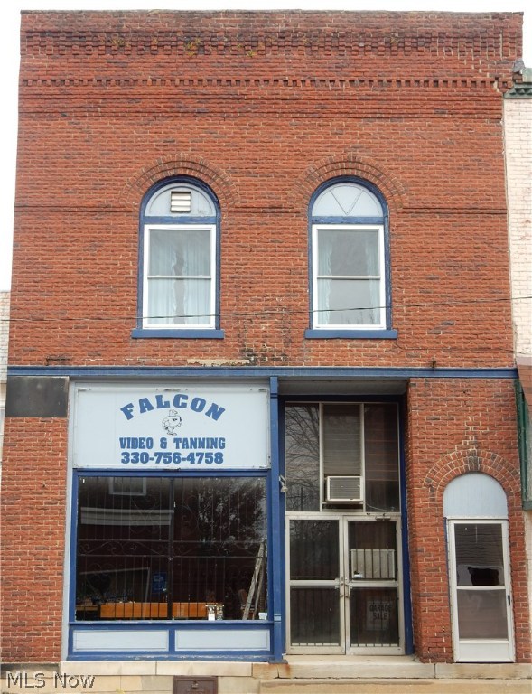 Wonderful opportunity for residential business. This historic building has potential just oozing from it. Live in the spacious apartment on the second level and have a business on the main level. The possibilities are endless. Once the first bank in the quaint village of Beach City, which still has the vault in tact. It won't take much imagination to return this building to a more original state and open it up to the public to patronize. Brick under the paneling, copper ceiling under the commercial dropped ceiling and hardwood floors under the carpet. The apartment offers a large open living area, 2 bedrooms, which are currently tandem but could easily be changed to have two separate entrance and one bathroom There is a water meter and heat source for the apartment, separate from the business. The apartment offers a front and back entrance. This is a nice secure building on the main street. Call for your private showing.