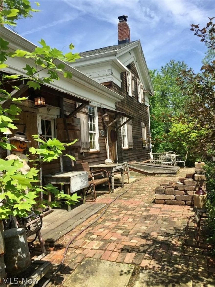 Remarkably restored to it's original construction, this fabulous century home is looking for a new owner. Nestled on a 2 1/2 acre wooded retreat in Sharon Twp (Highland Schools). There are numerous plumbing and electrical updates. SPECIAL FEATURES include : natural gas, 1st floor owner's bedroom with updated bath, stainless steel appliances, 1st floor laundry/mud room, dining/hearth room with fireplace, living room with second fireplace, walk-out basement, and 4 spacious bedrooms upstairs. One upstairs bedroom is currently used as an office and another is large enough that it was used as a family room.  NEWER: GE washer & dryer, stove, refrigerator, roof, insulation, cedar plank siding, shutter and doors, gutters with gutter guards, well pump, and hot water tank. You'll enjoy walking the beautiful gardens with large patio for outdoor dining, and areas of the yard that have vintage electrical lighting. To further enjoy your country home, there is a 14x10 outbuilding with a stall and cov