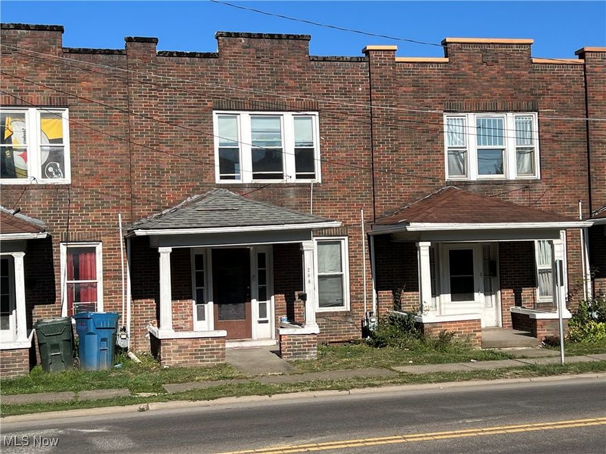 Great location if your looking to be in town for this townhouse.  It has 3br. 1 1/2 bath 1 car garage in the basement with alley access. and a small porch to sit and relax on.  The home would make someone a great starter home or use as a rental.  There's a spacious living room and a large dining room, small kitchen with appliances and full basement with laundry hookups and ample storage.  The home has hardwood floors throughout and is ready for showings.  All this with in town convenience.  Call today.