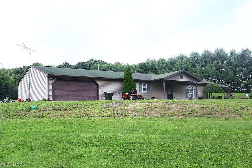 COUNTRY & PRIVACY JUST GO TOGETHER!!  Check out this open concept Ranch Style home with 2 bedrooms, 1 bath and a two car attached garage sitting serenely on a full acre of beautiful land and mature trees. ENJOY dinner in the LARGE eat in kitchen featuring GORGEOUS cabinetry and plenty of counter space  or RELAX with company in the SPACIOUS living room with French double doors leading outside! This home was built in 2002 and includes the dishwasher, range and refrigerator!  A SMALL price to pay for peaceful living!