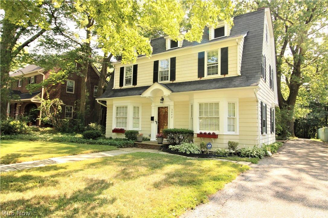 Gorgeous Shaker Colonial style home with 4 bedrooms, 2.5 baths, and 2 car garage on a quiet street! Formal dining room with built-in cabinets. A four-season sunroom, Spacious living room with built-in fireplace. Private backyard with patios and beautiful landscaping. The main bedroom features a private balcony with a seating area. Updated kitchen. Updated bath with ceramic tile. Refinished hardwood floors throughout. Other features: ceiling fans, full waterproofed basement with sump pump. Walking distance Van Aken STA station. Near Shaker square. Violation free. Move right!