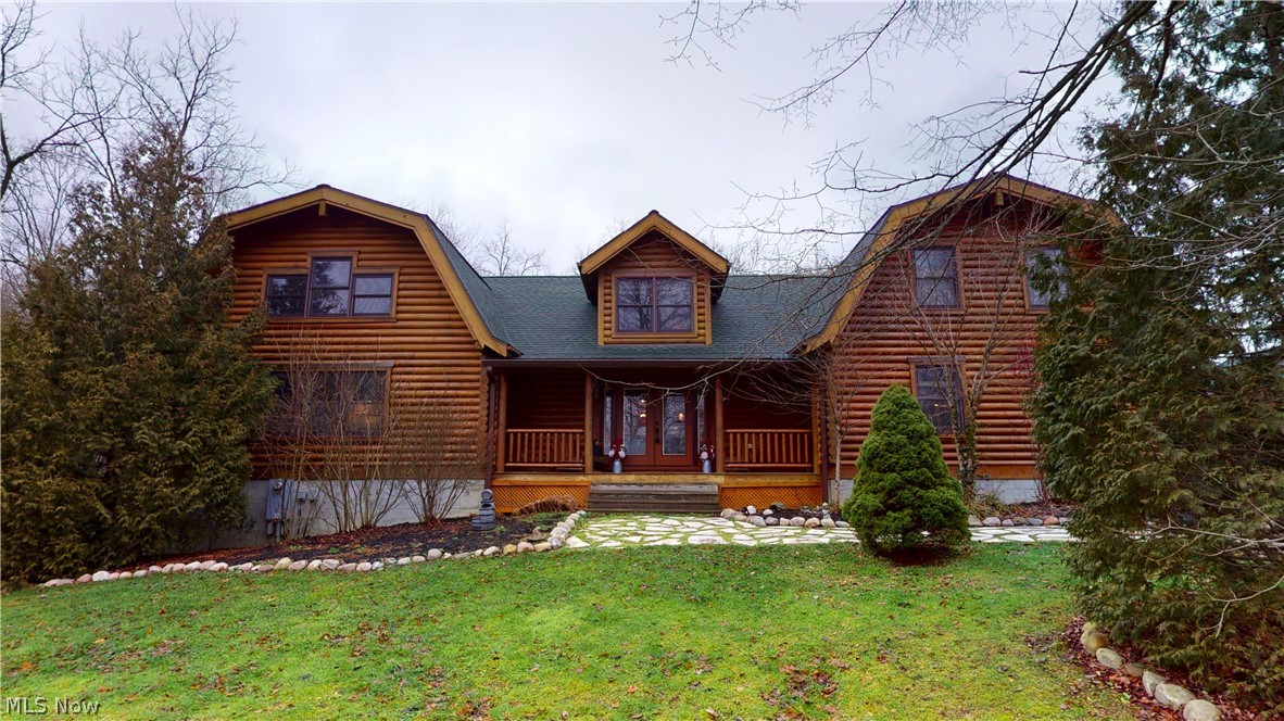 Welcome home to this picture perfect, stunning log cabin home nestled on 3+ serene wooded acres. Come on in from the inviting front porch into the spacious open floor plan complete with wood floors, beamed ceilings, & custom built with full logs that have insolation in between. The fabulous custom kitchen features abundance of counters, large island/breakfast bar, & newer stainless steel appliances, wine fridge, hardwood cabinets & is all open to the vaulted great room & dining area. So convenient for entertaining or just relaxing. Huge master suite with built in closets, vaulted ceilings, & full bathroom. The half bath & laundry room finishes the first floor. Going up the Knotty pine stairwell to the upstairs you will find another 2nd master/loft with a private bath that includes double sinks, soaking tub, walk in shower & a outside balcony overlooking the gorgeous backyard. There are 2 full bathrooms, 3 more bedrooms, & two lofts upstairs. So much space for working at home. Walk out