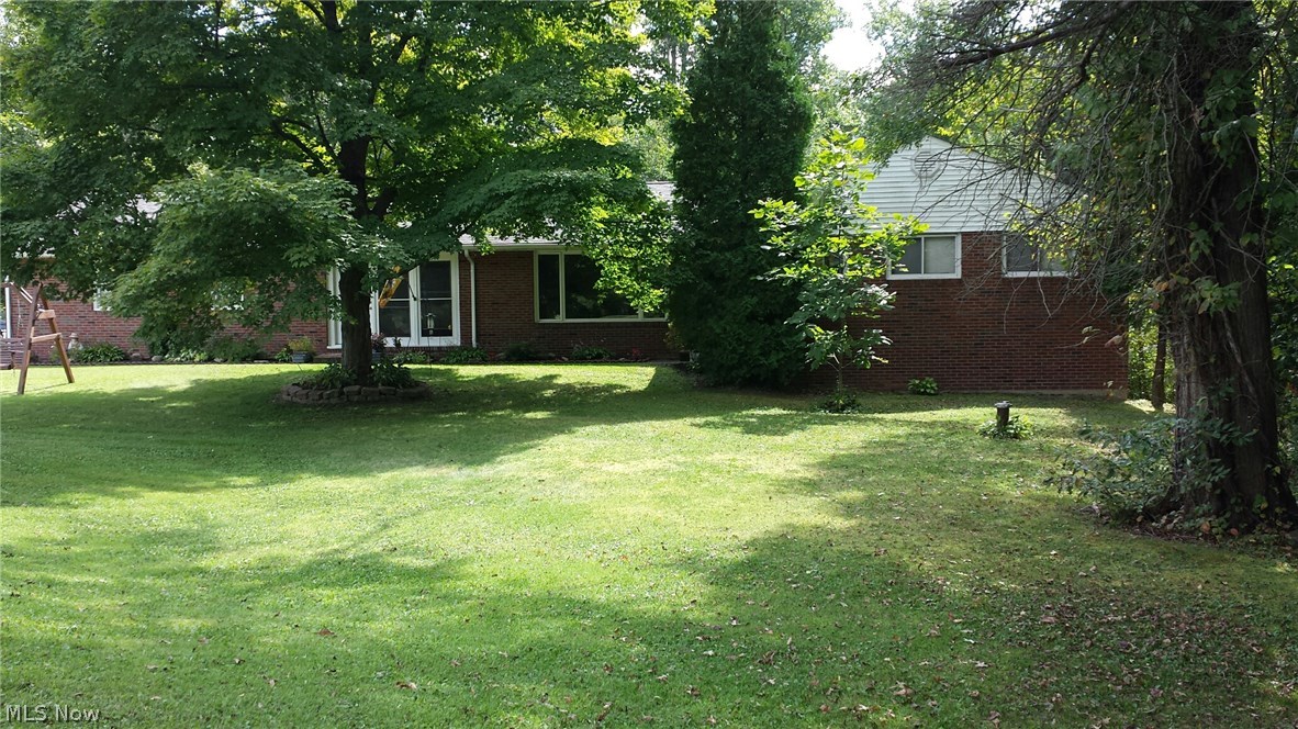 Come home to nature! This well maintained and updated brick ranch has charm and location. The spacious rooms, updated kitchen, baths, boiler, and electrical, make this home move in ready. The enclosed porch with fireplace adds an additional 312 square feet of living area for large gatherings. The walkout basement has two additional finished rooms. The recreation room with fireplace and a craft room, office or bedroom, adds another 544 Square feet of living area! The acreage is partially wooded, but also has a lovely manicured lawn with a pond, and outdoor picnic area. The two level deck is just a step away from the enclosed porch.