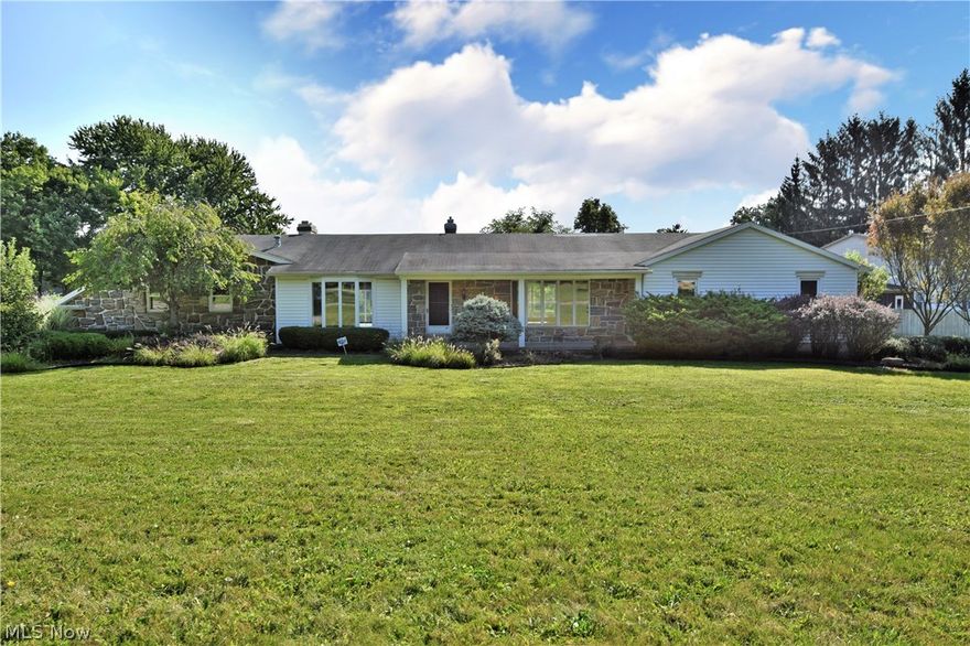 A freshly updated ranch home filled with big rooms and sun filled living! An outstanding home, splitting two cross streets, this residence allows for instant access. Tall trees and formal landscaping surround the home to accent a stepped patio area and robust sunroom. Natural stone facing provides a rich look on the formal front of the home. Inside, fresh updates find you surrounded in calming gray walls paired with bright white trim work and natural colored carpets. A large formal entry way divides both living and great room areas alike with closet space and a half bath. Multiple rows of windows light each side of the residence. The massive great room boasts hardwood floors and a stone fireplace before revealing the sunroom and kitchen entries. The new 2018 kitchen itself is filled with rich, ash colored cabinets and granite countertops. Stainless appliances lend a sleek and modern feel. The formal dining room leads towards the main hall where three sizeable bedrooms branch off, each
