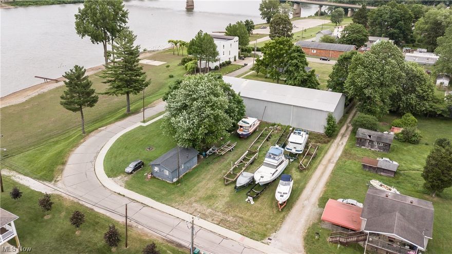Exceptional Development Opportunity with Ohio River Views

Situated on approximately 1.258 acres, this versatile property presents an outstanding opportunity for residential or commercial development. Enjoy scenic views of the Ohio River along with convenient access to a nearby public boat dock, making it an attractive option for investors, developers, or owner-occupants seeking location and potential.

The site currently includes a large warehouse, two residential homes, and a garage apartment. One home is presently rented, while the other two residential structures offer value-add potential and are ready for renovation or improvement.

Zoned 2AX, the property permits both residential and commercial uses, offering flexibility for a variety of future plans. Zoning restrictions prohibit medical marijuana facilities and exotic clubs. All proposed construction or development must meet city and zoning approval requirements.

Included parcels: 13-3-25B, 13-3-25C, and 13-3-25A.

The large metal building measures approximately 20' high × 50' wide × 134' long, providing substantial space for storage, operations, or redevelopment possibilities.