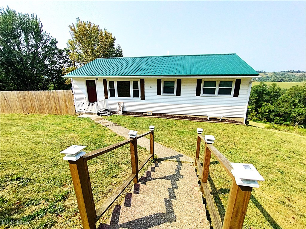 Sitting on 8 parcels totaling 1.28 acres is this 3 bed, 1 bath ranch style home that has updated flooring, paint and a side yard with privacy fence for the kids and/or pets to freely play without a worry. This home is located on the edge of town, just outside of the corporation limits in a quiet setting looking across miles of tree tops and into distant meadows. The full basement can be accessed off of the kitchen and just outside the back basement door is where you will find the newer hot tub that will transfer to the new homeowners. Per the home owner there is no RITA tax which is instant savings versus living within the city limits. All the kitchen appliances are additional bonuses as well that will follow you into your new home. Contact your agent and arrange a time to see if this home checks your boxes!