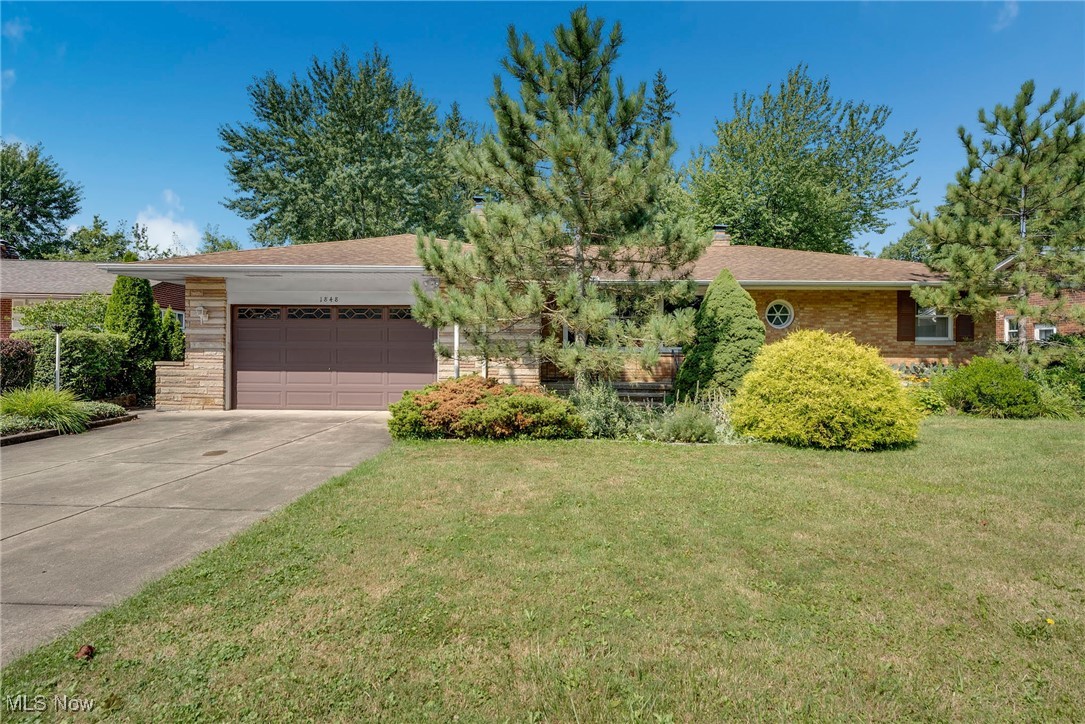 Welcome to this well-maintained brick and stone ranch in desirable Alberta Estates, offering the ease of one-floor living and abundant space both inside and out. Step into the spacious living room, where you'll find beautiful cove ceilings and a striking stone electric fireplace. The living room opens to the formal dining area, highlighted by hardwood floors and two built-in corner china cabinets, creating the perfect space for entertaining. The kitchen features ample cabinet space, a tile floor, and a cozy eat-in area. Adjacent to the dining room is a delightful four-season sunroom, filled with charm and natural light. Beyond that, enjoy a large three-season glass room that overlooks the patio and private backyard—ideal for relaxing or hosting guests. A convenient half bath sits just off the kitchen. Three bedrooms with hardwood floors share a generous full bath featuring a large tiled tub/shower combo. The lower level adds even more living space—half finished with wood-paneled walls, a built-in bar, and a wood-burning fireplace, perfect for a rec room or family gatherings. The other half offers work bench and fantastic storage, including a wall of closets. Additional features include a backyard storage shed to free up garage space and a prime location within walking distance to the neighborhood park, which offers tennis courts, ball fields, a splash pad, and playground. A great home with great space in a wonderful setting—don’t miss it!