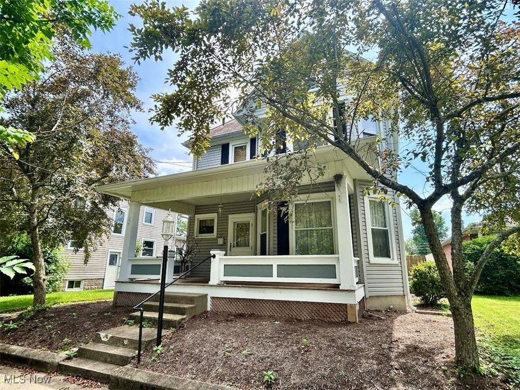 Great downtown location and close to all amenities! This three bedroom, 1.5 bath home offers a traditional front porch, inviting foyer, spacious living room/dining room combination with fireplace and a family room off of the kitchen. Other features include newer hardwood flooring on the staircase and in the kitchen, walk-up attic floored for tons of storage and side porch that leads to the back patio. The back yard is fenced and level with landscaping areas. There is an oversized two car garage on the alley with a work bench and parking pad. The front porch was rebuilt in 2021, gutters were all replaced around the top roof line, first floor furnace and air conditioning units were replaced approximately eight years ago. Schedule your private touring appointment right away!