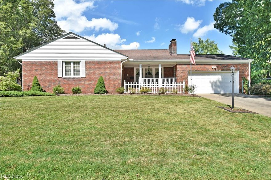 Treat yourself to the casual comfort of this all-brick Hubbard ranch, delighting with its diverse landscaping brimming with floral views. A picket lined and covered front patio leads you inside to find a relaxing, carpeted living room as a wood trimmed accent wall showcases a stone mantle with inset fireplace. Sculpted crown work follows overheads with a wrapping upper trim board, creating a unique opportunity for décor. Just past the dining area, a substantial sunroom drops away with its large, tiled flooring and advantageous gas heater for all-season use. The central kitchen enjoys hardwood styled flooring with matching cabinetry. A floating island includes easy additional dining space as needed. Nearby, the main hall passes by a sizeable full bath before finding a pair of inviting bedrooms. Hidden first floor laundry is located nearby. Completing the floor, an oversized master bedroom is finished with its own half bath. Down below, the full basement provides provisions for a lower family room with fireplace, fourth bonus room with cedar cabinet, large workshop and a third half bath.