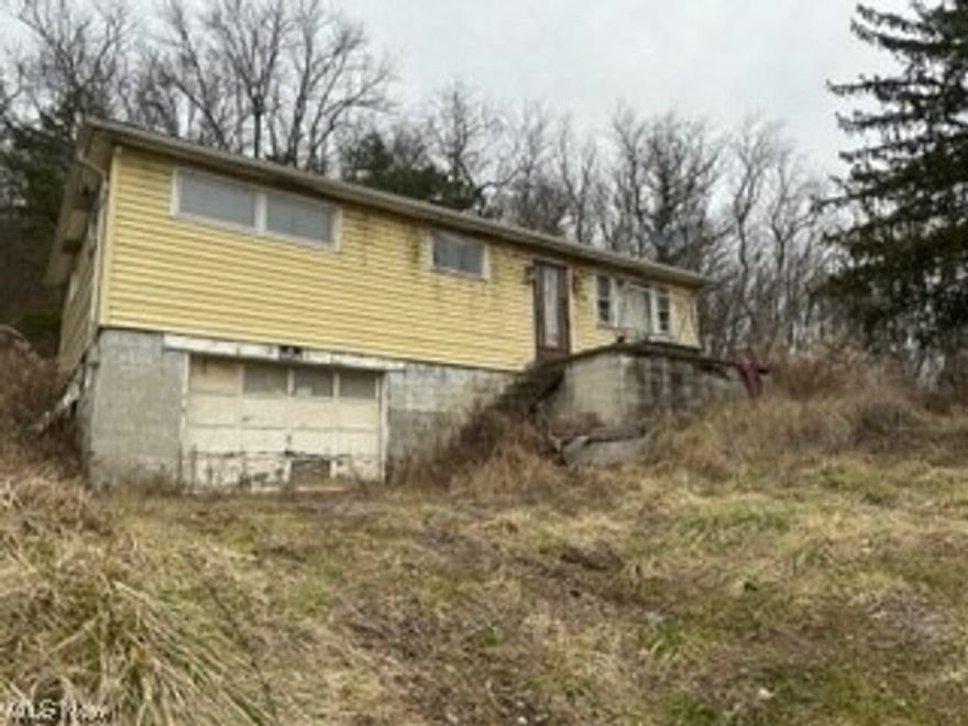This mid-century modern ranch style home offers all of the clean lined features and quality materials of a very unique era. Natural wood trim graces windows and doorways which compliment the real hardwood floors that are still in very nice condition.  Just polish them up and enjoy the warm natural sheen! The house needs some love and attention and a definite cleanout, but the bones are good.  Best of all, a new owner can enjoy the partially off grid features of their own well and septic.  The home sits on a private 4.3 acre lot with plenty of room for outdoor activities, gardens, hiking or games. The drive can be smoothed out and re-graveled for easier access, or if you really like the privacy - keep the access by four wheel drive the way it is now and avoid uninvited guests! Perfect for preppers or home steading buyers.