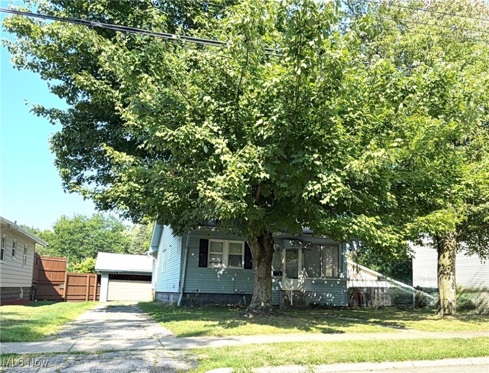 This home is much larger than it looks! Take advantage of a great opportunity to make this home your own! This home has so much to offer! A HUGE finished basement that was waterproofed by B-Dry approximately 20 years ago. New sump pump installed this June. Glass block windows... some are vented. Enjoy summer days on your enclosed, screened porch with Jalousie windows! Central AC. Kitchen with wood cabinets, built in cooktop electric stove. Built in oven. Convenient mudroom/pantry off of back door & kitchen. Vinyl insulted windows. Detached 2 car garage has concrete floor. Garage door opener is not working. Easy yard to maintain. NEW CARPET August 2025! Priced To Sell. SELLER IS SELLING AS IS.