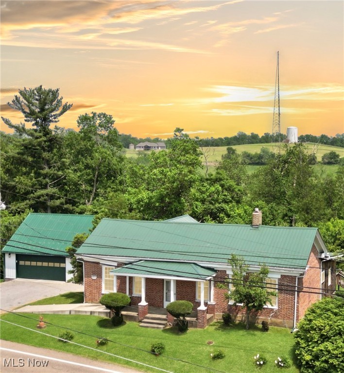 Originally built in 1830, this charming farmhouse sits on 12.125 surveyed acres and features a stunning 2.5 to 3-acre lake located toward the back of the property—just a short walk from the home and barn. The house has seen many updates over the years, including a remodeled eat-in kitchen, updated breaker box, and replacement vinyl windows. A new steel roof was installed on both the house and the detached two-car garage in October 2023. The gas furnace is approximately 10 years old.
Inside, you’ll find beautiful original woodwork and built-in bookcases. Two fireplaces add character to the space, though they are decorative only. A covered front porch with a newer cement ramp adds accessibility, while a covered side porch provides a second entry into the dining room. From the kitchen, step out onto a large back deck that overlooks the 24-ft round, 4-ft deep above-ground pool.The property also includes a three-sided barn that could be finished and enclosed to suit your needs. The septic system has already been approved by the Jefferson County Health Department.
The spacious bathroom includes an adjoining room that could serve as a dressing room, office, or even be converted into a master bath.And don’t forget one of the property’s most unique features: the beautiful lake, just a walk away, offering a peaceful natural retreat right in your backyard.