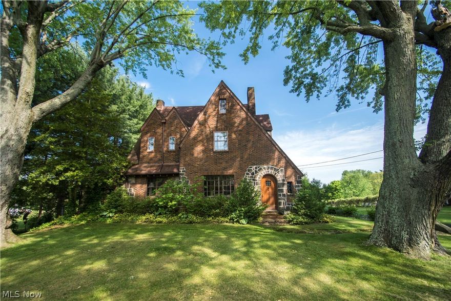 Absolutely adorable Tudor on almost 2 acres and looks like it is out of Pottery Barn.  Remodeled cherry kitchen with granite counters and stainless steel appliances.  First floor office and hardwood floors in living room and dining room.  Living room professionally decorated with a gas fireplace.  New stamped concrete patio off the dining room with new french doors.  There are 3 bedrooms upstairs with a huge walk in closet with customer cherry cabinets.  Finished rec room with wood burning fireplace and a laundry room.  This home WILL NOT DISAPPOINT.