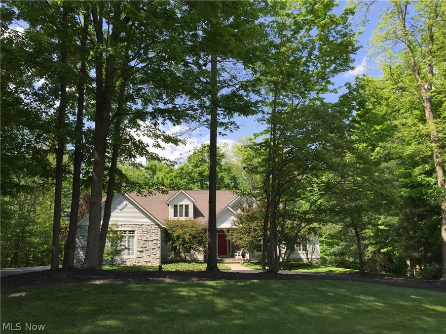 Gorgeous home with a versatile & open floor plan that's nestled perfectly on a wooded lot with an idyllic setting. Circular driveway with attached 3 car garage. 
First floor flows beautifully with a main floor master suite with gas fireplace, a library that can easily be a first floor bedroom with attached full bathroom, a lovely gazebo style Sun Room overlooking the back yard with soaring ceilings, a formal Dining Room & a stunning Living Room with vaulted ceiling, hardwood floors, brick gas fireplace & windows overlooking the rear of the property. Kitchen has black & stainless steel appliances, wood cabinets & center island plus a skylight. There's even a built in desk/workstation area. Gleaming hardwood floors on first floors that compliment the perfect blend of natural cherry, maple, poplar & white woodwork. Huge 2nd level with high ceilings & unlimited finishing potential - flooring, dormers & windows have been installed ready for your decorating decisions. Finished lower level o