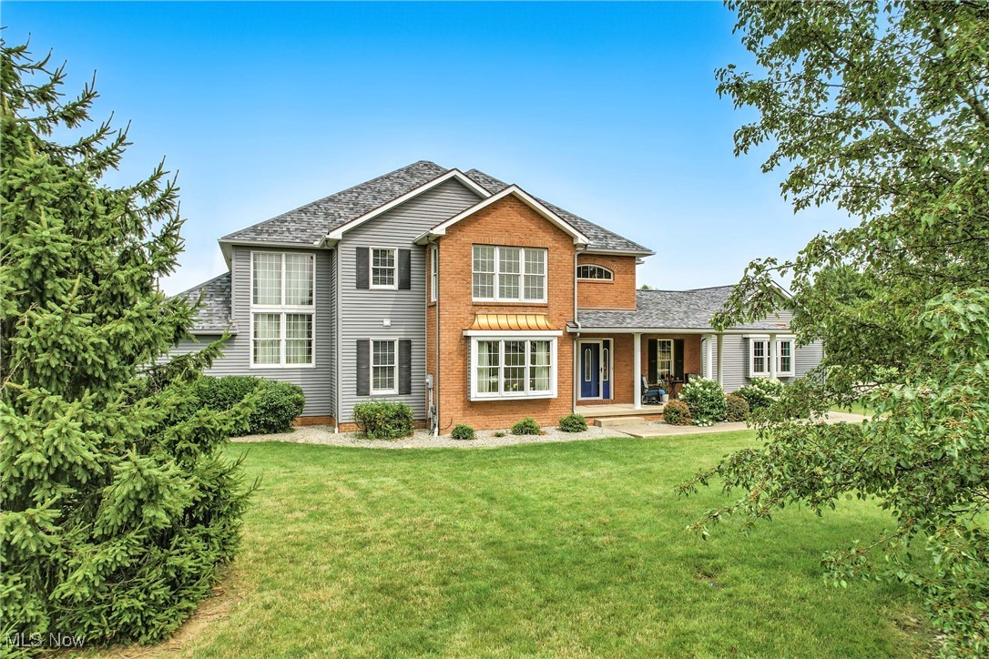 Welcome to this stunning four-bedroom, five-bath home offering over 5,700 total square feet of living space in the desirable Oak Hollow development within Champion School District. Overlooking a gorgeous stocked pond, this beautifully built home offers elegance, comfort, and modern updates throughout. The grand foyer leads into a spacious great room with 17-foot ceilings, a gas fireplace, and beautiful hardwood floors that flow into the formal dining area. The updated kitchen features new cabinetry, quartz countertops, and a large eat-in area, perfect for family meals and entertaining. The first-floor master suite includes a Jacuzzi tub, stand-up shower, dual sinks, and a walk-in closet. Also on the main level are a large office, a first-floor laundry room, and a four-season sunroom with lovely pond views and access to the fenced-in patio and backyard. Enjoy outdoor living with a fantastic brick patio and fire pit at the pond’s edge, perfect for relaxing or entertaining in a beautiful waterfront setting. Upstairs are three additional bedrooms—one with a half bath, walk-in closet, and pond views; another spacious bedroom with a double closet and pond view; and a third generously sized bedroom. The upstairs hallway overlooks the great room below, adding to the home’s open and airy feel. The fully finished basement expands the living space with a second kitchen, a bonus room, a gym (or potential additional bedrooms), and a full bath, offering flexible options for guests or multigenerational living. All appliances will stay.
Recent updates include two AC units (one installed in 2021, one in 2025), two 2 new furnaces (2021) a hot water tank (2021), and a new roof (2021), ensuring peace of mind and energy efficiency. Additional highlights include a four-car garage, a whole-house generator, and a brick and vinyl exterior with copper accents. This exceptional home is truly a rare find in Champion!
