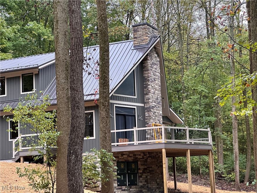 Custom builder, Walnut Valley Log Homes, took one of its most desirable floorplans that they build and improved it. View some of the pictures below of the completed home which this home was modeled after. This floorplan has been very well received. Crafting this home, the builder made it larger, and fine tuned it idyllically for this wonderful 1.3 Acre Wooded lot full of Mature Trees that perfectly frames the home. You will appreciate the lovely Lakehouse Style and Low Maintenance of the Cultured Stone, Vinyl-Sided Exterior and Metal Roof. When you are at the lake you want to enjoy the activities, solitude, and relaxation of your home; not be a slave to the maintenance. As you arrive you are welcomed by a 36-foot covered porch which beckons you to sit and take in the solace of the treed side yard; even on a rainy day. As you enter the home you are greeted by the Soaring 2-Story Great Room with its featured Prow Wall w Soaring Cultured Stone Gas Fireplace, flanked by 2 PELLA Sliding Doors w Transom Windows to invite you out to the large Trex Deck. The Great Room adjoins the Open Kitchen with a Breakfast Bar Island, Hickory Cabinets & Granite Countertops. There is a Private 1st Floor Master Suite w the privacy of ensuite bath & convenient washer & dryer hookup. The upper level boasts a Loft overlooking the Great Room & Fireplace and with Views of Nature through the Dual 2nd Story PELLA Trapazoid Windows. This spot can be your reading area, computer nook, etc. There also are 2 more bedrooms and a full bath on the upper level. The full Basement encompassing 1,200sqft is pre-plumbed for another full bath for future expansion to the new owners desires. There are Sliding Doors in the basement which lead to a 360sqft concrete patio perfect to walk out to a relaxing area for a future firepit. Intuitive pre-planning, the builder put an egress window w stepped window well for a future additional bedroom if the new owner desires. YOU WILL LOVE EVERYTHING ABOUT LAKE BUCKHORN !!!