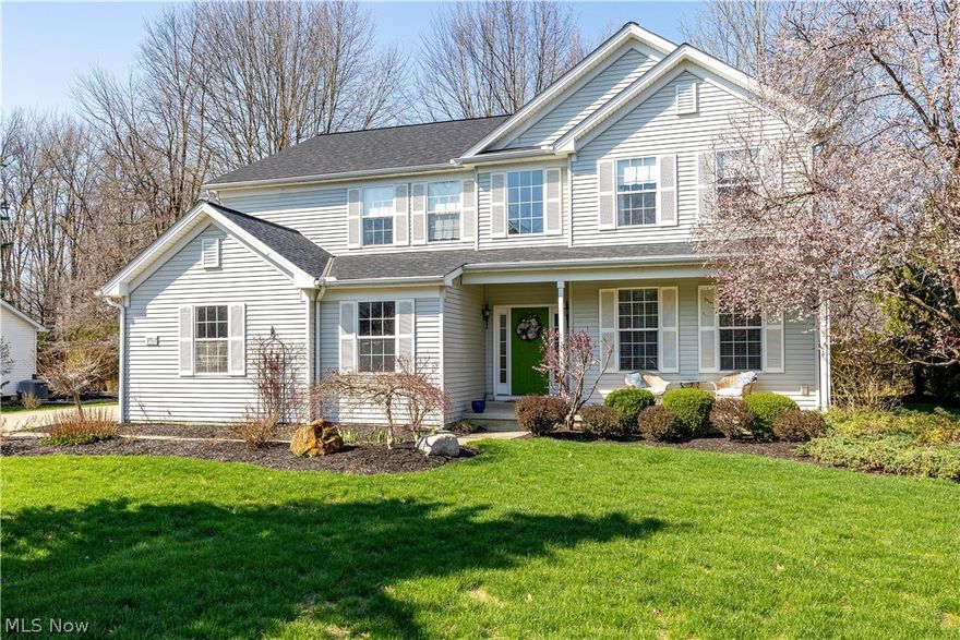 This beautifully maintained 4–5 bedroom, 3 full bath home offers an inviting open floor plan, highlighted by an impressive 18-foot foyer ceiling and abundant natural light throughout. The front living room is filled with sunlight, delivering a warm yet refined ambiance and creating an elegant first impression.

The main living area is centered around a stunning gas fireplace with a stone veneer surround, framed by expansive windows that enhance the home’s bright, airy feel. Rich hardwood flooring with carpet inlays flow throughout the first floor, while the foyer and hallway feature durable ceramic tile. The formal living/dining room and foyer are accented with classic crown molding, perfect for gatherings and entertaining.  The large, open kitchen has a wonderful center island for additional seating and a  built in desk.  The thoughtfully designed primary suite is privately situated from the additional bedrooms, offering a peaceful retreat with two walk-in closets and an en-suite bath featuring dual vanities, a soaking tub, and a separate walk-in shower. A first-floor flex room—currently used as a bedroom—sits adjacent to a full bath, providing excellent versatility for guests or multi-generational living. The first-floor laundry room includes a large window and exterior man door for added convenience.

The full, unfinished poured concrete basement with high ceilings offers exceptional potential and is already plumbed for a future bathroom. Outdoors, the backyard is intimate yet private, surrounded by mature trees and complemented by a stone patio—ideal for enjoying the serene setting.

Additional highlights include a three-car garage, new roof (2025), and a 75-gallon hot water tank (approx. 4 years old). Community amenities include an association pool and playground, enhancing neighborhood living along with the expansive Lorain Metroparks just across the street.