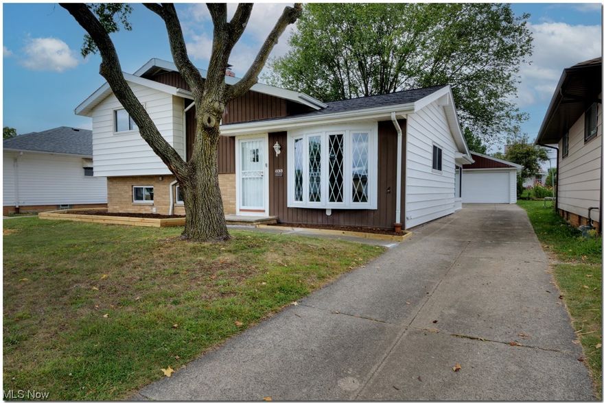 This home offers a well designed open concept.  Front door leads you into a spacious vaulted living room with newer flooring and opens to a state of the art kitchen with a breakfast bar and dining room.  Kitchen features high quality shaker cabinets with granite countertops and stainlesss appliances.  Ample natural lighting throughout; allowing this open concept floor plan to be perfect for entertaining or simply relaxing. Three large bedrooms and a full modern bath make up the second level living.  The finished lower level offers a recreation room with a remodeled 1/2 bath w/granite countertops.   Large laundry area provides you with abundant storage space. The updates include in 2023: new roof on home and garage, new vinyl windows, new flooring throughout first level and lower level and sunroom, updated lighting, throughout, upstairs bathroom, new flooring, cabinet, lighting & plumbing updates.  Lower level 1/2 bath updated with tile backsplash with granite counters.  New flooring in