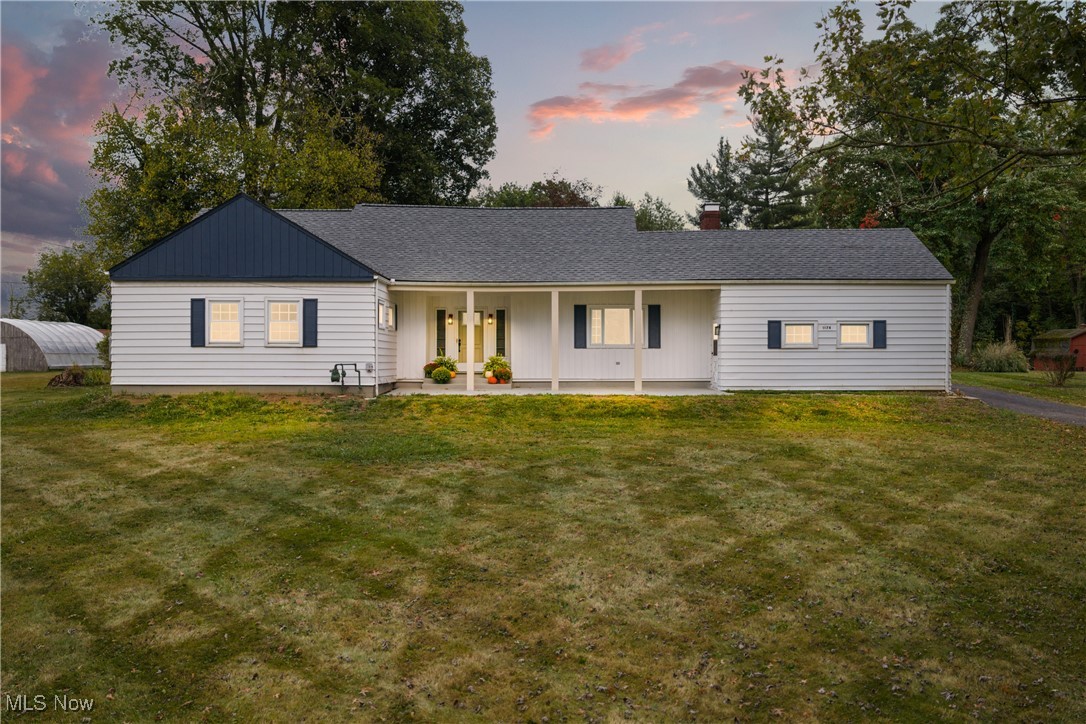 Back on the market at no fault of it's own! Welcome to this beautifully renovated 3-bedroom, 2-bath ranch nestled on a private 1-acre lot in North Lawrence, backing up to Hole 5 of the Elms Country Club. Located in the sought-after Tuslaw School District, this stunning home blends modern upgrades with peaceful rural charm. Providing over 2200 square feet of living space, this charming home has so much to offer. Step inside to an extra-wide, impressive foyer that sets the tone for the spacious layout. The home features a gorgeous brand-new kitchen with quartz countertops, soft-close custom cabinetry, pantry with pull-out shelves, and breakfast bar flowing into a formal dining room—perfect for entertaining. The large living room boasts a striking stone gas fireplace and ample natural light. The spacious primary suite includes a generous closet and a brand new ensuite bath. Two additional well-sized bedrooms and a second full bath offer comfort and flexibility. The newly finished basement adds a large recreation room with new windows that let in natural daylight, providing extra space for relaxing or entertaining. Additionally, the lower level provides a laundry area & plenty of storage space. Major 2025 upgrades include:Roof, basement windows, A/C, septic system, sump pump, flooring throughout the entire home, fresh paint throughout, all new interior and exterior lighting, new garage doors, and so much more. Top to bottom, it has been fully renovated with pride. This home is move-in ready and offers the perfect balance of privacy, modern style, and a prime location. Whether you’re enjoying the serene backyard views of the golf course or exploring the surrounding countryside, you’ll absolutely love calling this place home. To top it all off, the seller and buyer both already conducted septic, well, and general inspections to make certain they didn't miss a thing - make sure to ask for a copy of the reports! Don’t miss this rare opportunity—schedule your showing today!