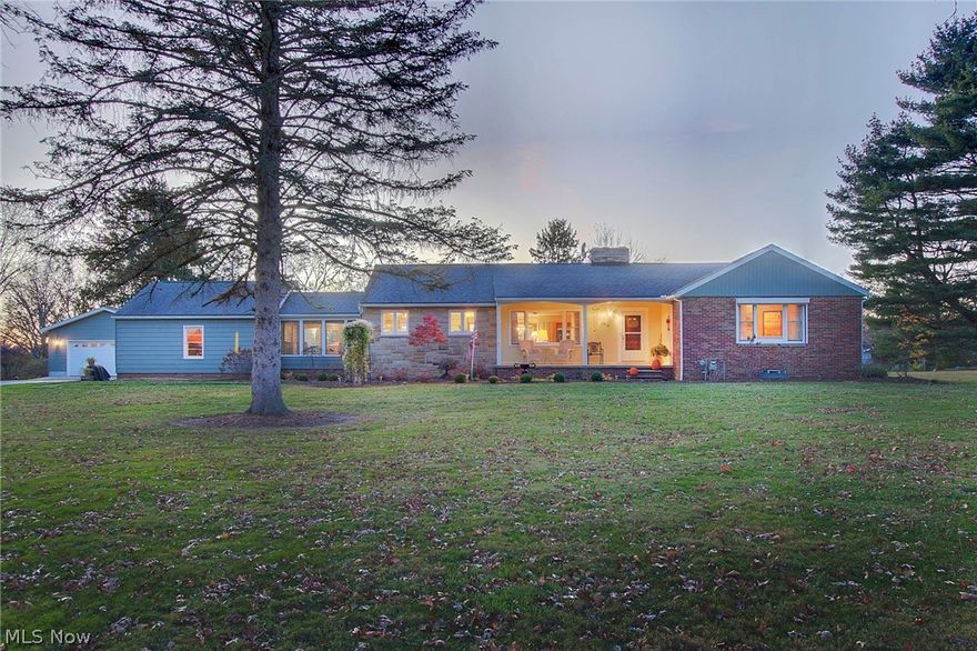 This ranch home in Norton on 1.3+ acres radiates warmth and original,solid craftsmanship. Whether you come in the front door through the large covered porch or the garage/ man cave with it's knotty pine walls, you will notice how well built the home is. The oak hardwood floors are original and in excellent shape! The L shaped great room boasts a stone gas log fireplace, large picture windows and a dining room on one end and an entry to a sunroom on the other. The eat in kitchen has been updated with a new refrigerator and microwave (2022) which remain. Nearby is the laundry/ half bathroom and right off the kitchen is the Breezeway with original Grooved mahogany walls and ceiling. The 3 large bedrooms each have cedar ligned closets and hardwood floors. The full bathroom is retro in excellent condition. The basement doesn't disappoint either. You'll notice the recreation room has laminate flooring and a wood burning fireplace and is ready for a party!
Updates include: 2022 glass block w