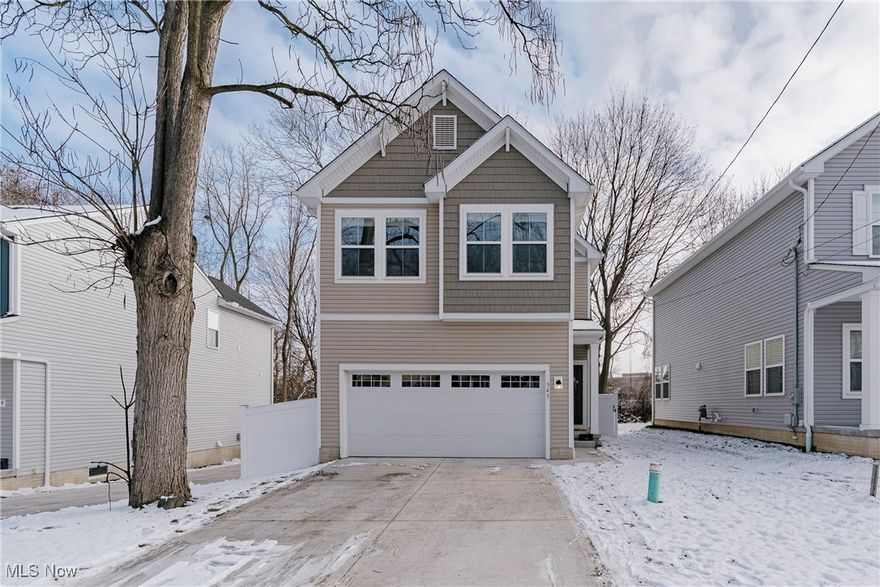 Welcome to 543 Rhodes Ave – A Newly Built Colonial with a Unique Modern Design! Beautifully crafted and thoughtfully laid out, this move-in-ready home offers the perfect blend of comfort, style, and functionality. With the sellers relocating for a job opportunity, this is your chance to own a like-new home in a convenient Akron location. Step inside the bright foyer, where the staircase sits to your left and the main living space opens straight ahead. The foyer flows into the sun-filled living room featuring an elegant gas fireplace, large windows, and durable LVP flooring that extends throughout the entire first floor. The open-concept layout creates a seamless connection between the living room, dining area, and kitchen—ideal for everyday living and effortless entertaining. The beautiful kitchen boasts a center island, sleek quartz countertops, stainless steel appliances, and a classic subway tile backsplash. Just steps away, the dining area offers direct access to the back patio through sliding doors, making it perfect for indoor-outdoor gatherings. A convenient half bath completes the first floor. Upstairs, a spacious loft/sitting area welcomes you at the top of the stairs and connects all three bedrooms. The private primary suite features a generous bedroom, walk-in closet, and a stylish ensuite bath with a double vanity. Two additional bedrooms, a modern full bath, and a dedicated laundry room provide comfort and convenience for the whole family. The full basement expands your living space with a finished rec room, a third full bath, and a utility room—perfect for movie nights, guests, or a home gym. Outside, enjoy a fully fenced-in backyard, freshly completed and ready for play, pets, or outdoor relaxation. Additionally, enjoy 13 years of remaining tax abatement! This newer home offers fresh, modern living in a location close to everyday amenities and commuter routes. Truly move-in ready and waiting for its next chapter!