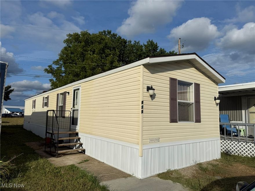 Convenient, 1 story living.  Well maintained 2 bedroom vinyl sided home.  Open floor plan with beamed ceilings.  Breakfast bar in the kitchen with corner sink and appliances included.  Handicap accessible bathroom with walk in shower.  Monthly lot rent of $250 per month.  Lease to be signed through June 2027.  Agent owned.