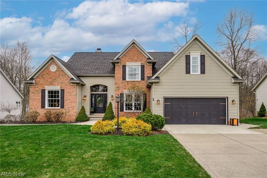 WELCOME HOME! This absolutely stunning colonial in the sought after Bayside Lake neighborhood in Stow offers 3800+ square feet of beautifully designed living space.This immaculate & well-maintained 5 Bedroom, 3.5 Bath home showcases exceptional craftmanship, on trend decor, and quality updates through-out. A dramatic two-story foyer welcomes you into the home, leading to a breathtaking two-story great room featuring custom board & batten accents, built-ins, a raised hearth gas fireplace, and a wall of windows that fills the space with natural light. The renovated kitchen is a showstopper with a large center island and breakfast bar,  granite countertops, stone backsplash, stainless steel appliances and a walk-in pantry. French doors open to the expansive deck - perfect for indoor and outdoor entertaining. A first floor laundry and powder room add convenience. The first floor owner's suite offers cathedral ceiling, cozy corner fireplace, custom trim and dual walk-in closets. The luxurious renovated bath features freestanding soaking tub, dual sinks and porcelain floor tile. Hardwood flooring throughout the main level. Upstairs, the loft overlooks the great room and bedrooms #2 and #3 feature walk-in closets. The main bath has been updated with LVT flooring. The walk-out lower level includes a spacious recreation area, a full bath and fifth bedroom with private exterior entrance - ideal for a home office, guest suite, play room, or flex space. Enjoy outdoor living on the expansive deck overlooking the private, fully fenced backyard, plus a covered patio below. 2 car attached garage. Neighborhood access to the Summit County Hike & Bike Trail and just minutes from schools, shopping, restaurants, Route 8 and the Ohio Turnpike! This is truly exceptional home that is updated and decorated to perfection - the perfect place to call home - just move-in & enjoy!