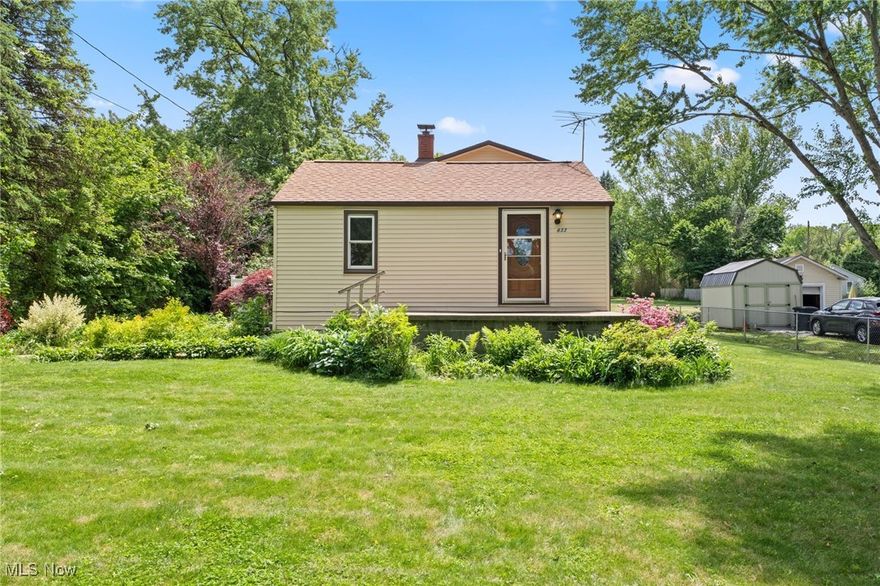 Charming Lake Retreat just steps away from the Long Lake Boat Ramp! This original Portage Lakes cottage has been upgraded with a Luxury Addition in 2014 which added an oversized 2 Car Garage, a Den and an Owner’s Retreat with Sitting Room, Primary Bedroom and a private Primary Full Bath. The addition has its own Furnace, A/C and Hot Water Tank for convenience. The cozy original cottage portion of the home has a Formal Living Room, 2 Bedrooms, an Eat-In Kitchen and Full Bath. The lower level has a carpeted Rec Room with Newer Glass Block Windows, a Wood Burning Stove and a Bar for entertaining family and friends. Storage abounds with a private Laundry Room and separate Utility Room. There is a New Hot Water Tank in 2025, New Sump Pump in 2024 and an entire house Water Filtration System. Outside is a Terrace with Privacy Fence, a Fenced Garden Area, Fruit Trees and beautiful Wildflowers. This home is ideal for pets with an Invisible Pet Fence and .62 Acres to run free. There is space for all of your toys outside with an additional Garage for a Boat Storage, a large Shed and a paved parking pad for RV storage. Come see the beautiful lake views and fall in love with Cove Blvd!