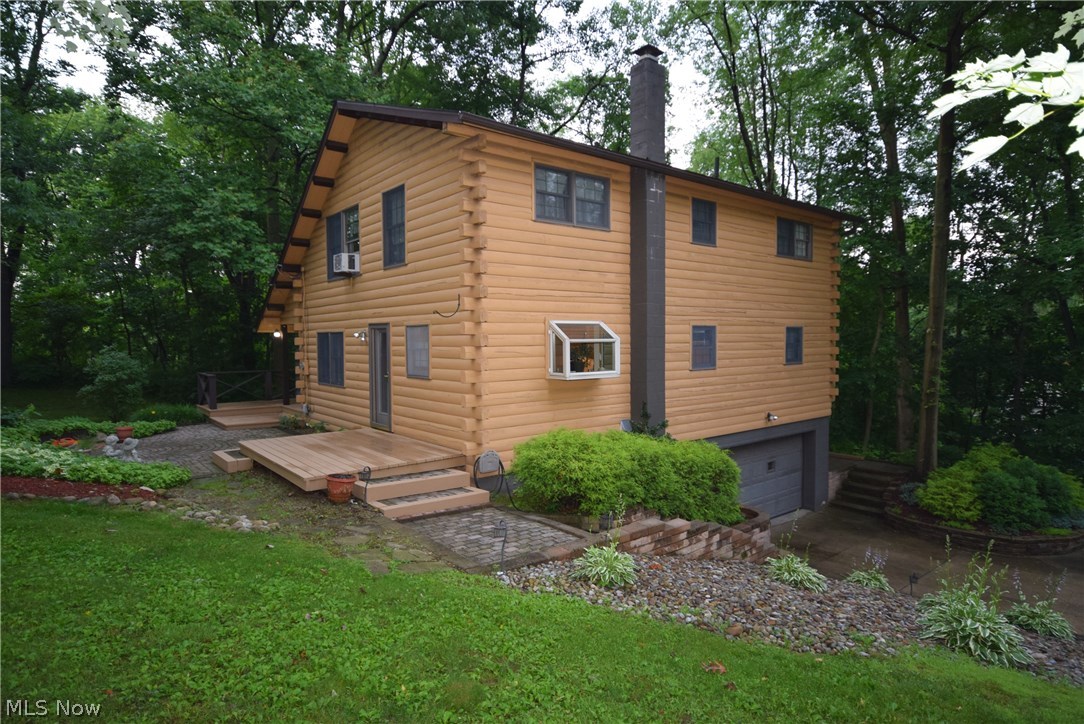 Make every day feel like a getaway in this 3-bedroom, 2-bathroom rustic log home. The wood burning stove and stone chimney in the living room make it a cozy place to gather around. The updated kitchen has been completely updated with new cabinets, granite counters and updated appliances, making it a great place to cook and entertain. Not only does this house have a gorgeous interior; it also has a large, elevated deck that allows you to enjoy the outdoors under covered roof or under the shade of the surrounding trees. Recent updates include a new roof, gas/boiler hot water tank, and leaf guard gutters. This property has the seclusion and entertaining space you've been looking for. Don't wait until this is sold! Call today for a private showing!