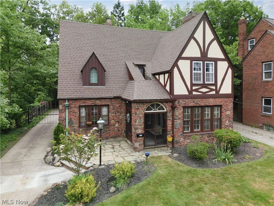 Welcome to this charming and meticulously maintained 1930 University Heights
Tudor. Prepare to be amazed by the architectural details, character and beauty
throughout. From the incredible and magical gardens, arched entryways, brick
and sandstone exterior to the oak hardwood floors are just some of the features
detailing this gem. The moment you walk inside you will experience the grandeur
of a beautifully updated approaching century old property. The amazingly
spacious and open first floor boasts a light filled living room with fireplace, an
additional sitting area or sunroom perfect for cozy reading escapes, an elegant
dining room, and a coveted first floor bedroom and full bath. The updated kitchen
is wonderfully apportioned for preparing delightful meals. That’s not all! The back
of the house features an additional finished living space with exposed brick,
perfect for a home office or entertainment. The second floor is complete with 3
additional bedrooms and a full bath. The lower level features a newly renovated
exercise room (2023) and a large laundry room. An abundance of storage is also
available in the lower level. One of the most stunning aspects of the property sits
on the nearly half-acre lot where you will find a beautiful flagstone patio, terraced
gardens and trees and water features. Escape in the beautiful gardens reading
novels of historical prominence of the homes’ original era. A detached two-car
garage with a slate roof beautifully adds to this gorgeous home. This home is University Heights POS compliant. Owner has never used fireplaces and does not know if they are operable.  Central air in the majority of the home.  Additional updates include a new first floor
bathroom (2023), new carpeting in office and master bedroom (2022), new boiler
(1 year old) and utility room enclosed (2023). Move in and enjoy the Heights
lifestyle in this wonderfully updated and maintained property. Schedule your
showing today!