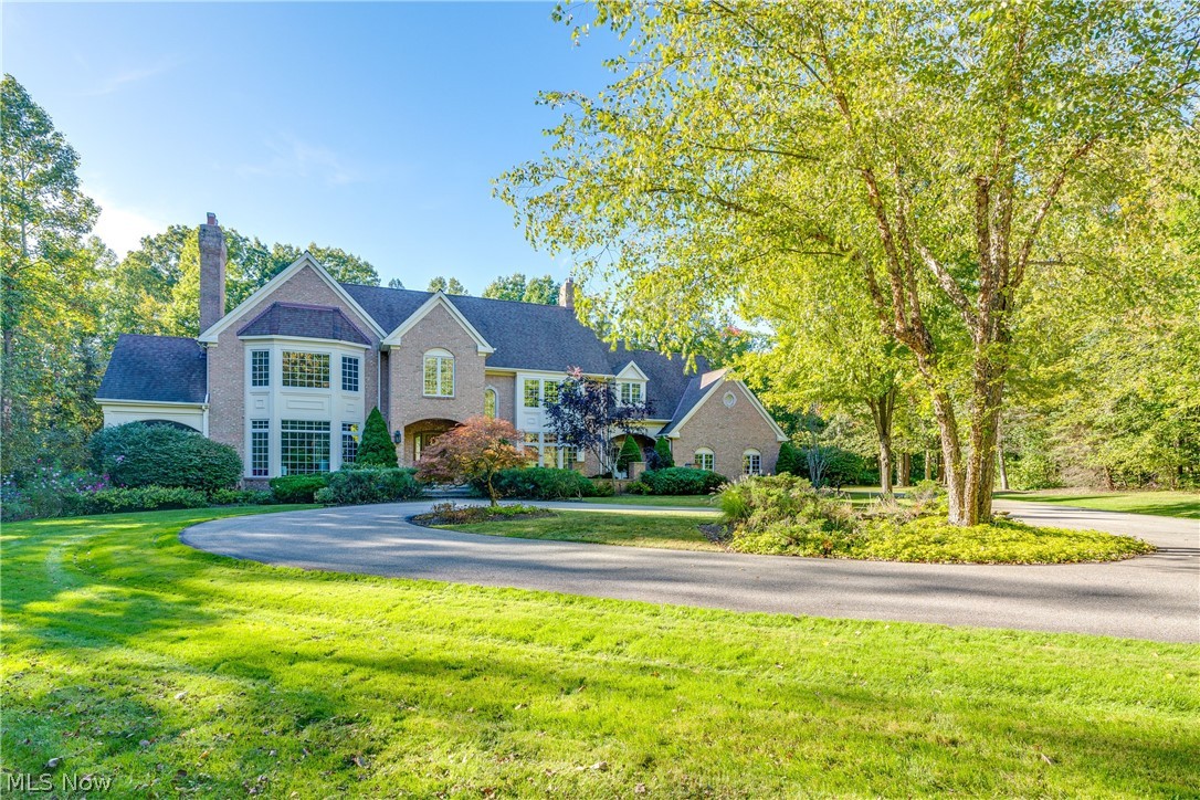 Sitting on 4+ private and professionally landscaped acres, this 5 BR/4.1 BA home offers comfortable living areas & exceptional outdoor views. An impressive circular driveway + stunning entry leads you into the light filled foyer. A comfortable living room w bay windows, fireplace & crown molding opens into the spacious dining room w hardwood flooring + french doors. The spacious and updated kitchen is an entertainer’s dream, fully equipped w Subzero Refrigerator, Bosch 5 Burner Gas Cook Top, Wine refrigerator, wet bar & white cabinets w subway tile. The kitchen opens into the large family room w additional fireplace + floor to ceiling windows that open onto a covered patio. A relaxing screened in porch, side entrance w mudroom, full bath and half bath complete this main floor. The upper level includes 5 bedrooms, 3 full baths with upper level laundry room. The owner’s suite is the pinnacle of luxury, featuring vaulted ceilings, cozy fireplace, his/her closets, bay windows & french door